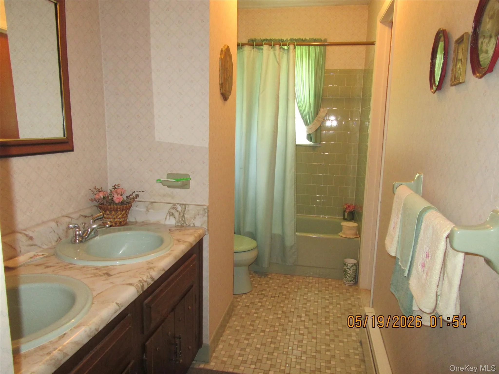 Bathroom featuring a dual vanity with integrated sinks, a patterned countertop, and a wood-finish cabinet base Bathroom featuring a dual vanity with integrated sinks, a patterned countertop, and a wood-finish cabinet base