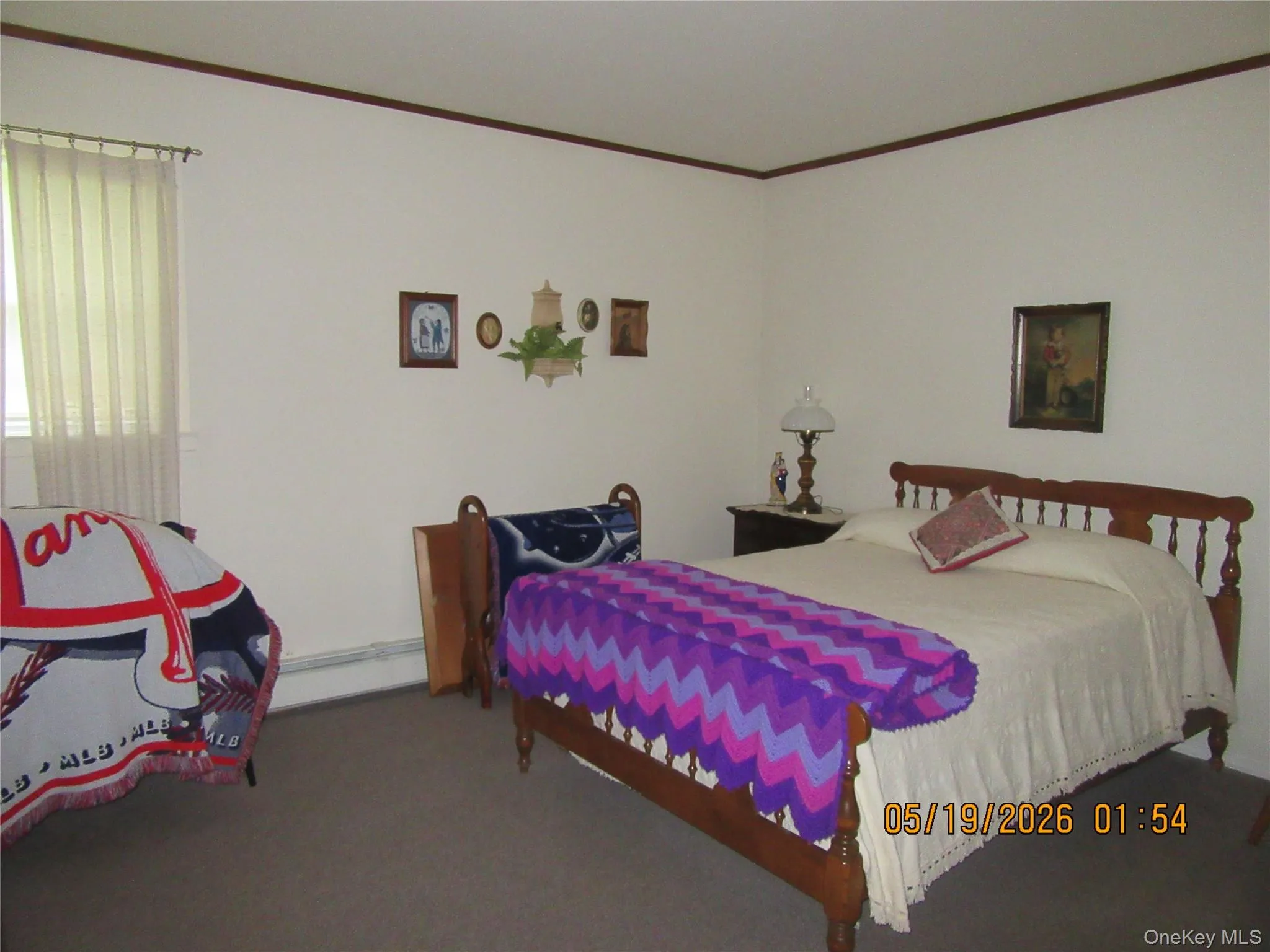 Carpeted bedroom with white walls and dark wood trim Carpeted bedroom with white walls and dark wood trim