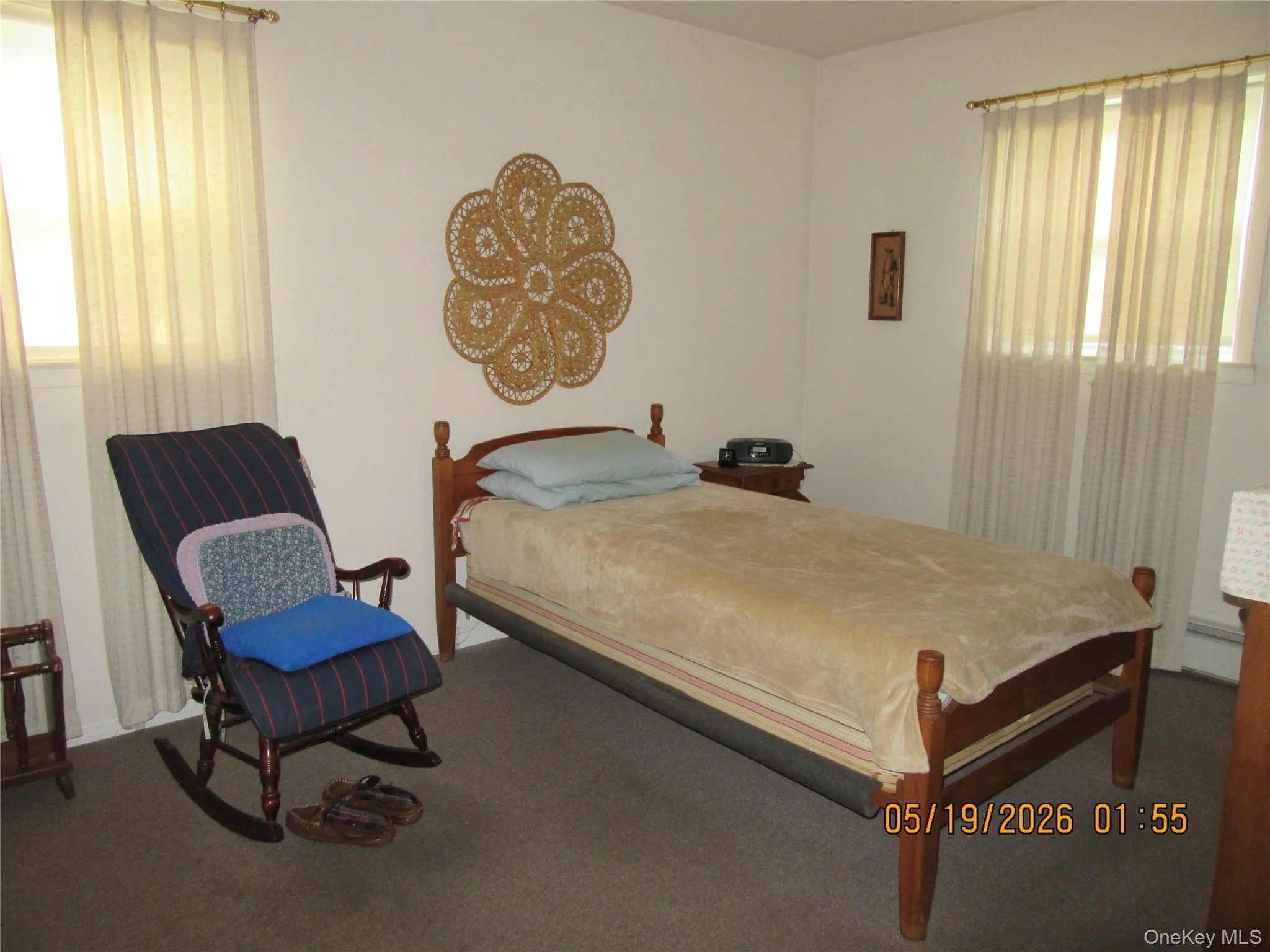 Carpeted room with multiple windows featuring vertical blinds Carpeted room with multiple windows featuring vertical blinds