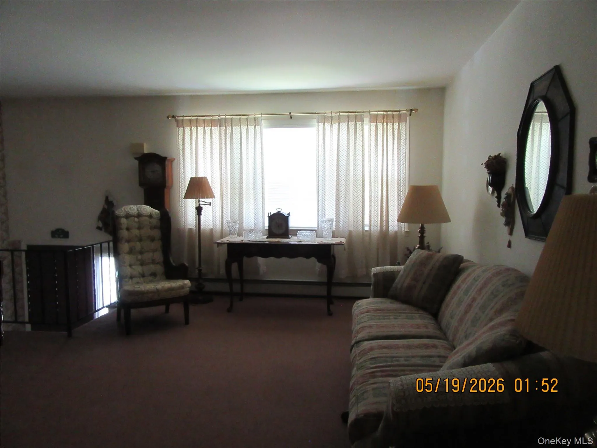 Spacious living area featuring expansive wall space, plush carpeting, and a prominent window Spacious living area featuring expansive wall space, plush carpeting, and a prominent window