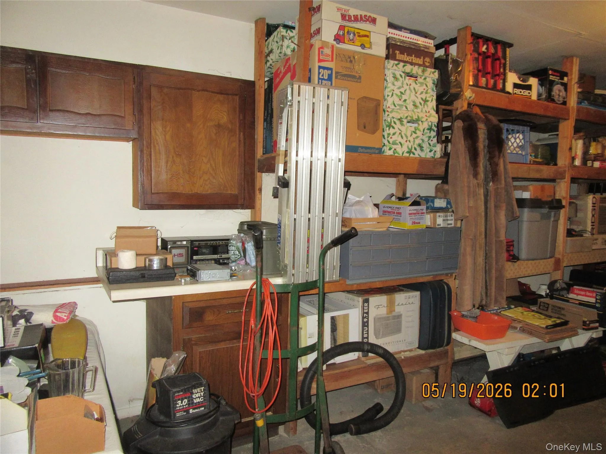 Utility area featuring wood cabinetry, built-in shelving, and a utility countertop Utility area featuring wood cabinetry, built-in shelving, and a utility countertop
