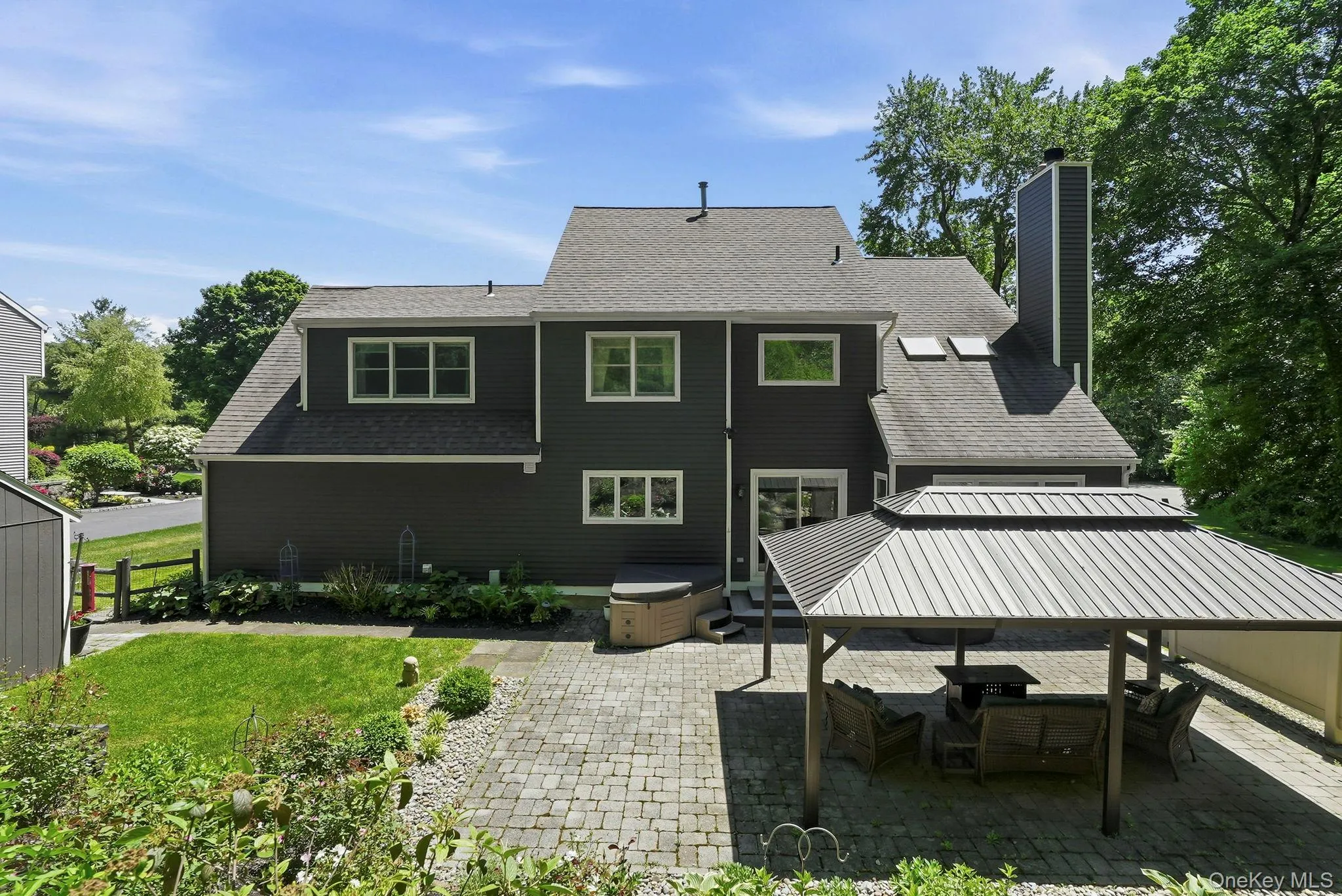 Step out from the kitchen to a level, stone patio with a pergola. Step out from the kitchen to a level, stone patio with a pergola.