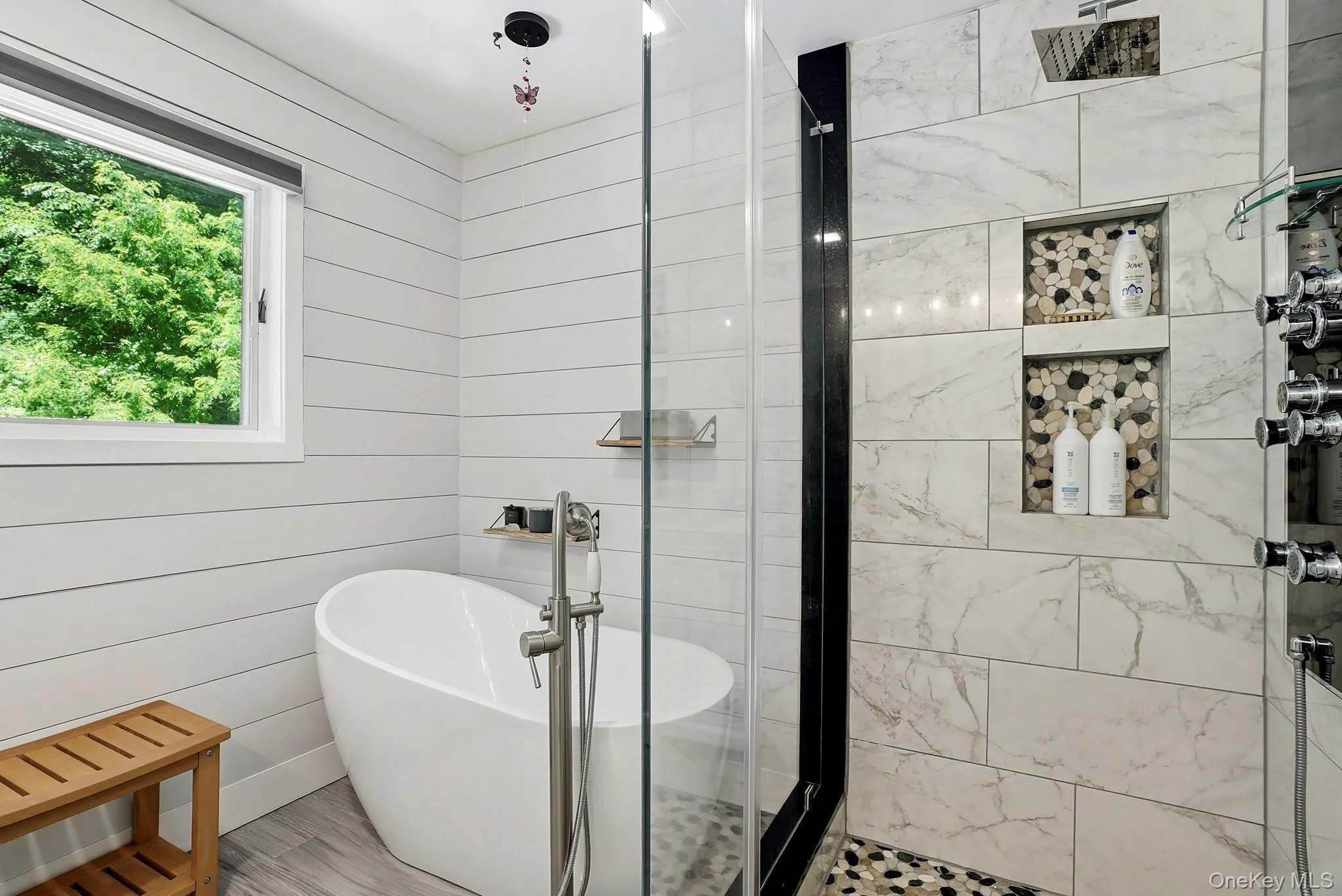 Enjoy a soaking tub, glass surround shower with a pebble floor and luxurious body sprays. Enjoy a soaking tub, glass surround shower with a pebble floor and luxurious body sprays.