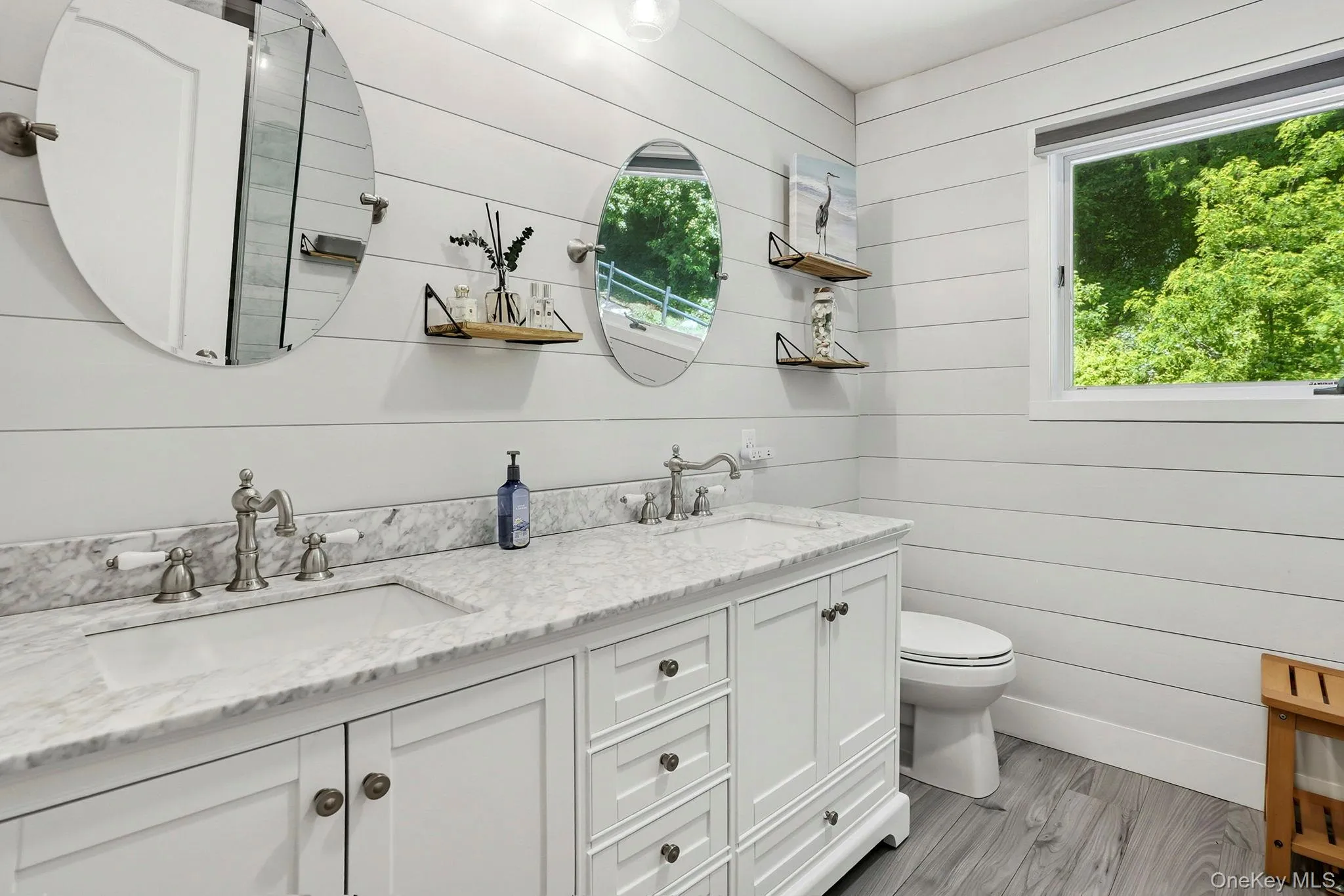 Lovingly updated in 2022 (est.), the primary bath has double sinks with a marble counter over a large vanity base. Lovingly updated in 2022 (est.), the primary bath has double sinks with a marble counter over a large vanity base.