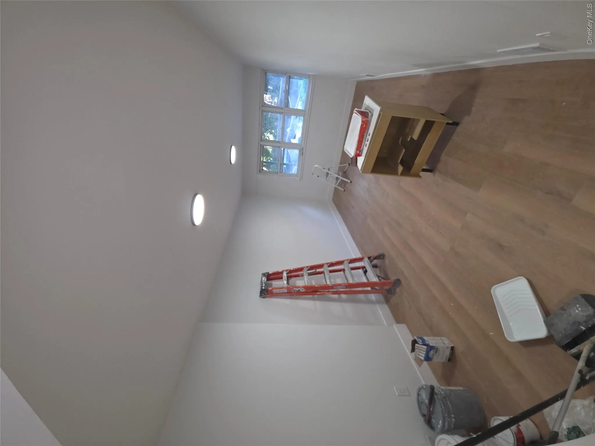 Room with wood-finish flooring, recessed ceiling lighting, baseboard trim, and multiple windows Room with wood-finish flooring, recessed ceiling lighting, baseboard trim, and multiple windows