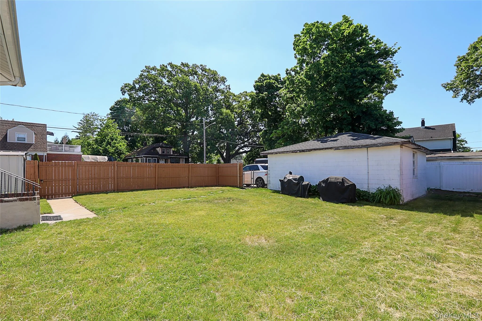 Expansive lawn area featuring a full privacy fence Expansive lawn area featuring a full privacy fence