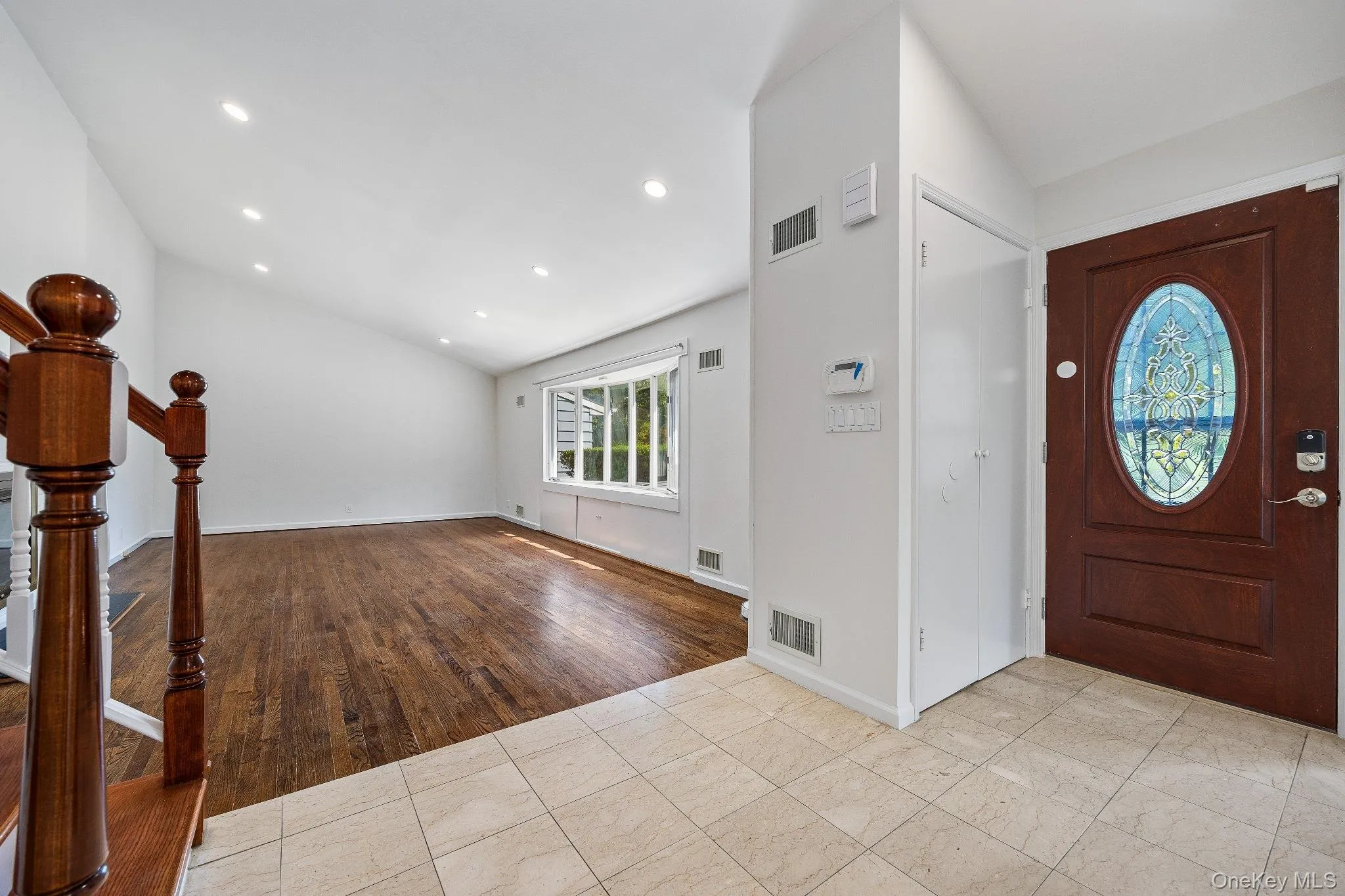 Entryway featuring recessed lighting, light wood-type flooring, vaulted ceiling, and stairs Entryway featuring recessed lighting, light wood-type flooring, vaulted ceiling, and stairs