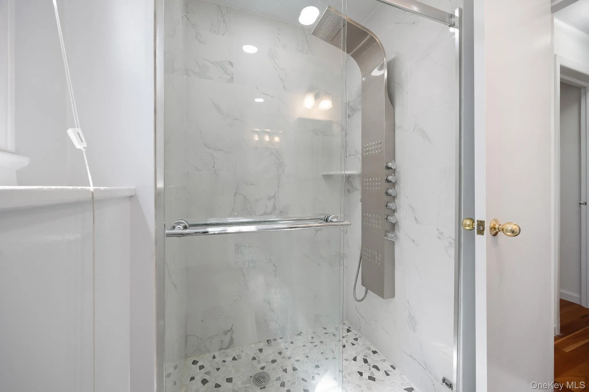 Bathroom featuring a marble finish shower Bathroom featuring a marble finish shower