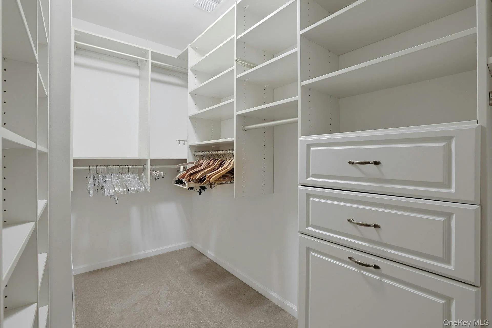 A large walk-in closet adds comfort and function to the primary bedroom suite. A large walk-in closet adds comfort and function to the primary bedroom suite.