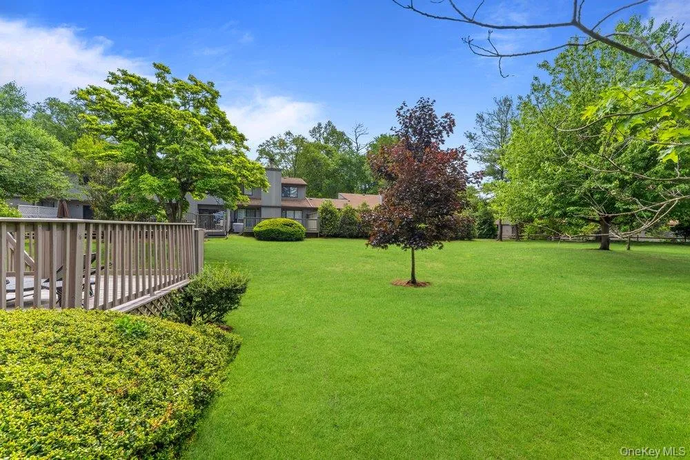 Expansive green lawn with mature trees and perimeter landscaping Expansive green lawn with mature trees and perimeter landscaping
