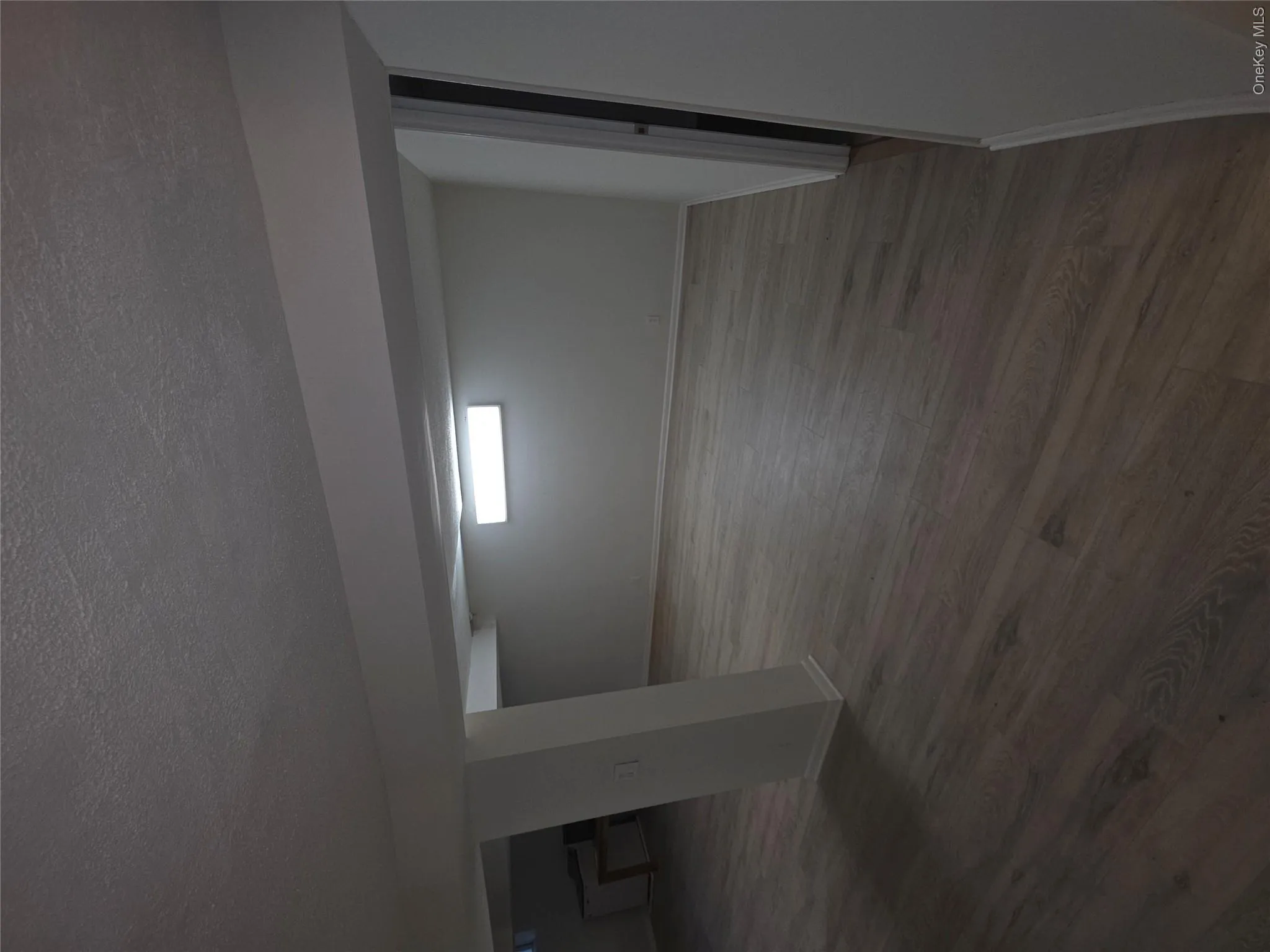 Expansive lower-level space featuring wood-finish flooring, recessed lighting, and a neutral wall palette Expansive lower-level space featuring wood-finish flooring, recessed lighting, and a neutral wall palette