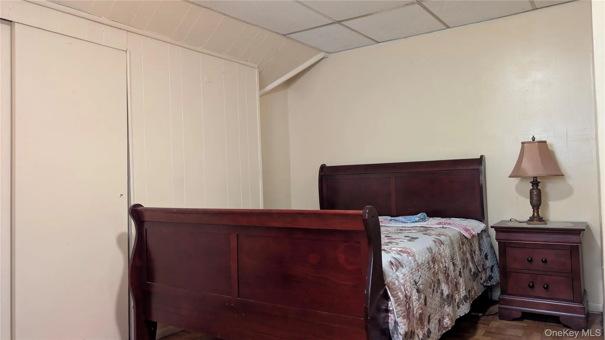 Room with paneled walls and a drop ceiling Room with paneled walls and a drop ceiling