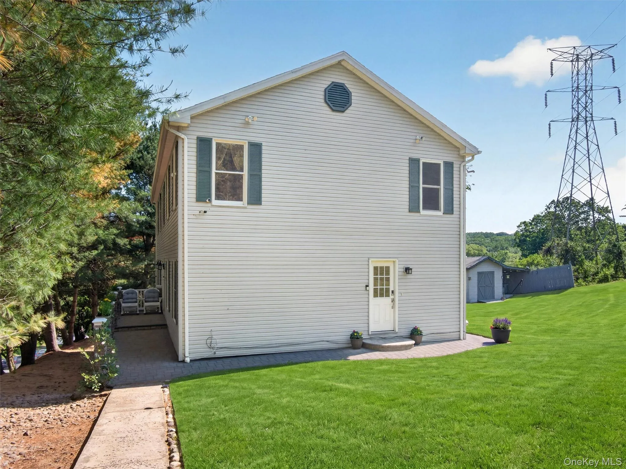 Different exterior angle highlighting the home’s size, updated exterior, and elevated setting. Different exterior angle highlighting the home’s size, updated exterior, and elevated setting.