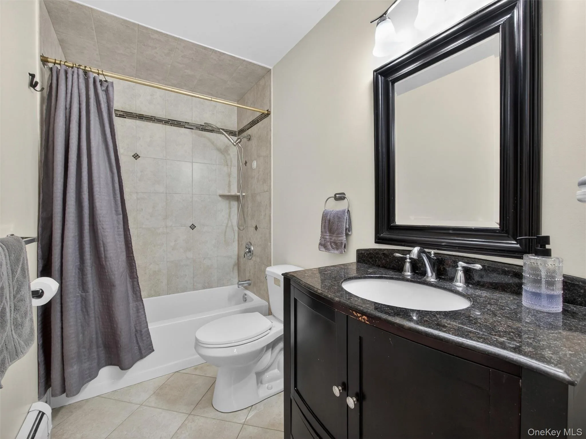 Full second-floor bathroom featuring a spacious layout, tub and shower area, and convenient access to the upper-level bedrooms. Full second-floor bathroom featuring a spacious layout, tub and shower area, and convenient access to the upper-level bedrooms.