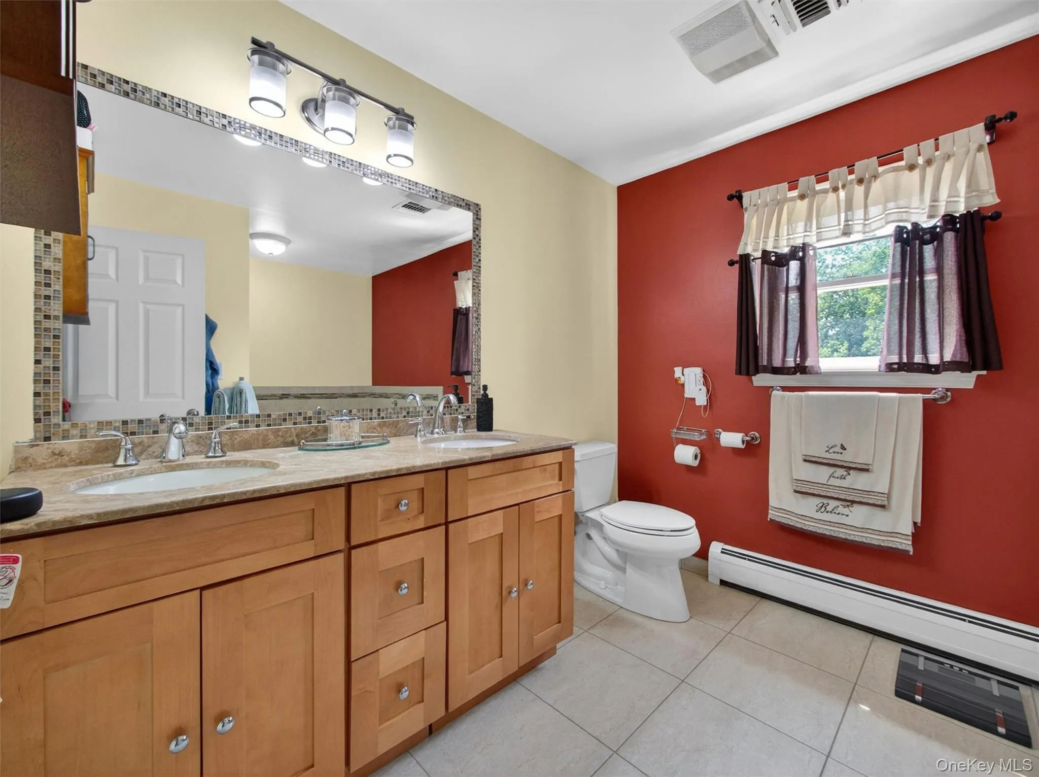 Spacious primary bathroom featuring a double vanity, granite countertops, and abundant storage. Spacious primary bathroom featuring a double vanity, granite countertops, and abundant storage.