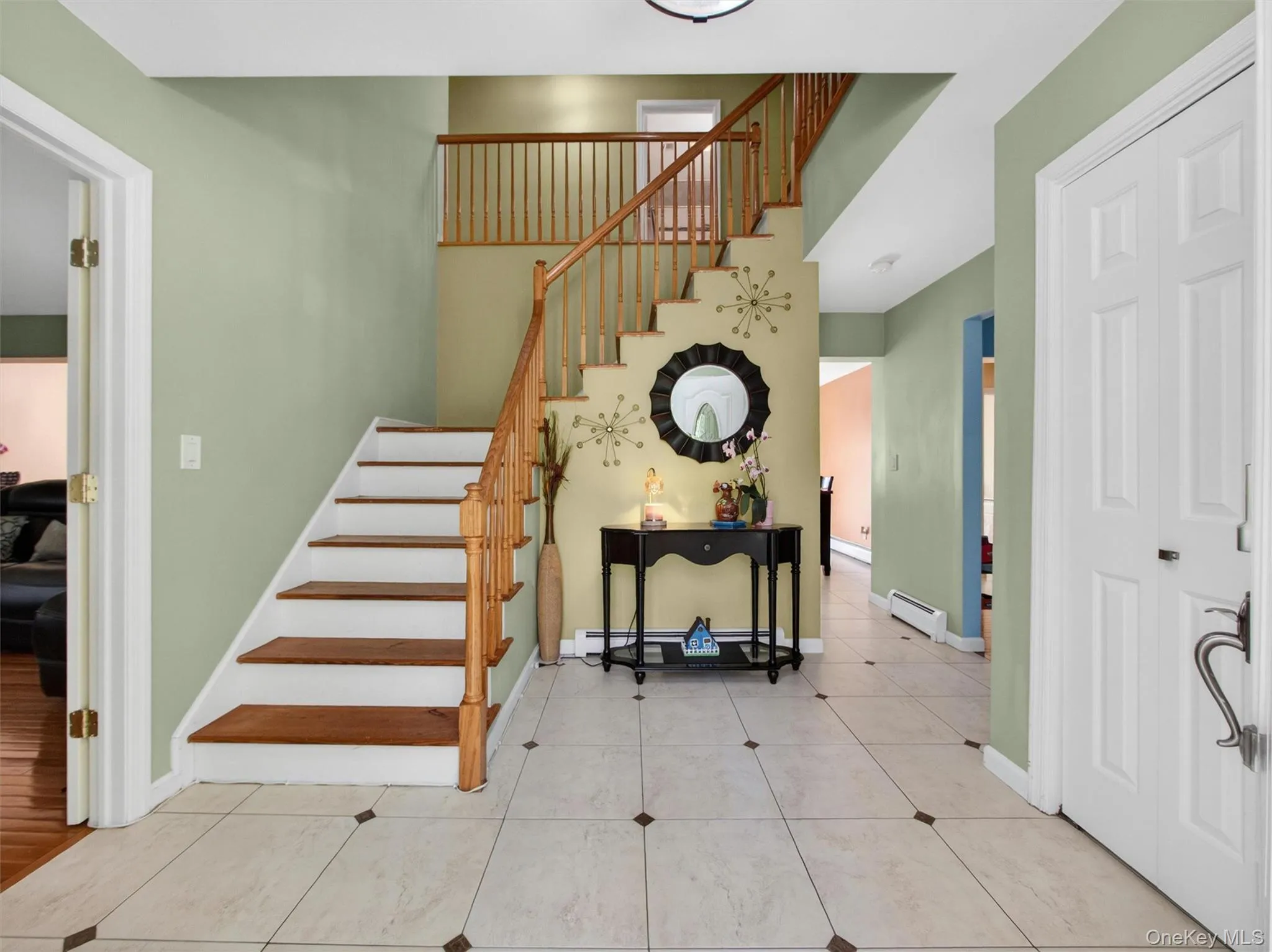 Inviting foyer entry featuring tile floors, soaring ceiling height, and staircase access to the second floor. Inviting foyer entry featuring tile floors, soaring ceiling height, and staircase access to the second floor.
