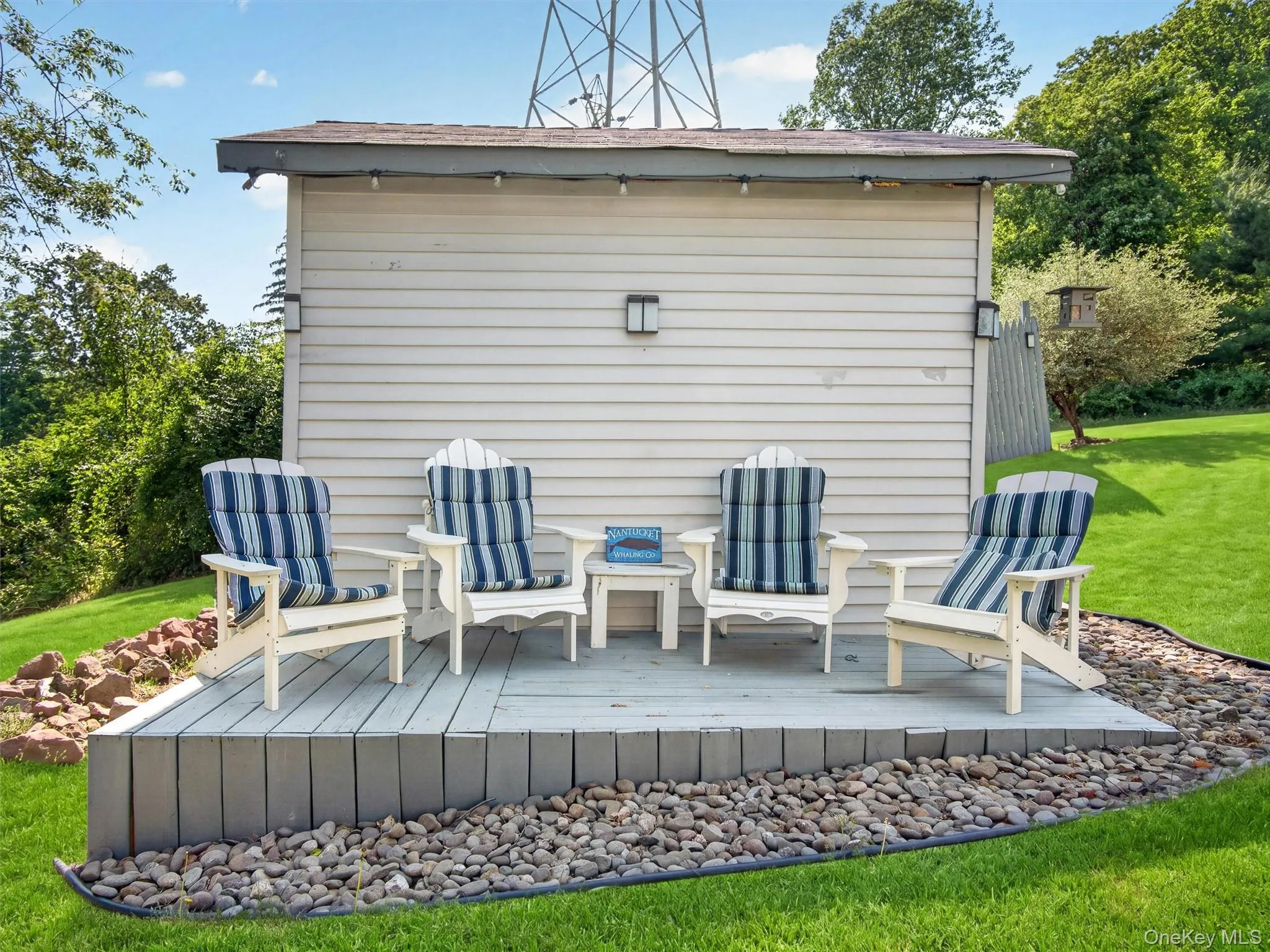 Additional outdoor seating area perfect for relaxing, entertaining, or enjoying the peaceful backyard setting. Additional outdoor seating area perfect for relaxing, entertaining, or enjoying the peaceful backyard setting.