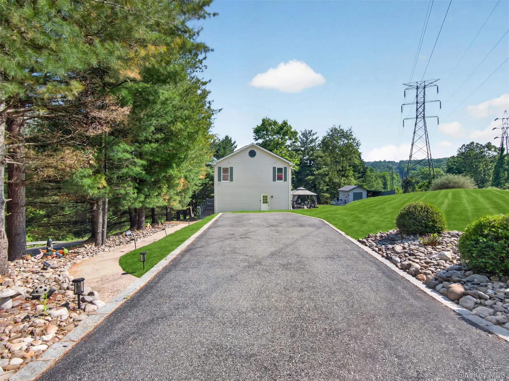 Long exterior view showcasing the expansive property and natural wooded surroundings. Long exterior view showcasing the expansive property and natural wooded surroundings.