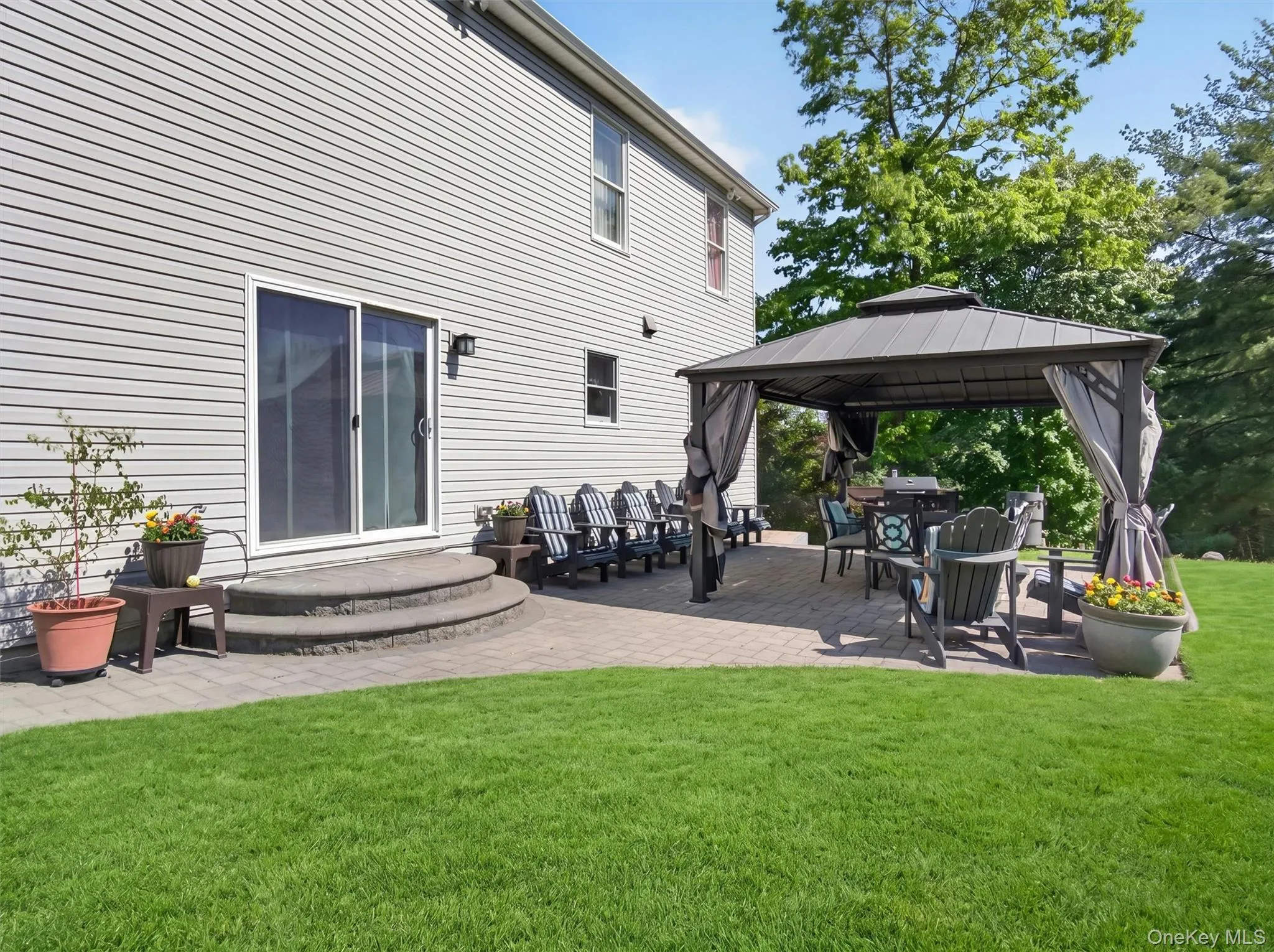 Beautiful backyard entertaining space with patio seating, landscaped grounds, and seamless outdoor flow. Beautiful backyard entertaining space with patio seating, landscaped grounds, and seamless outdoor flow.
