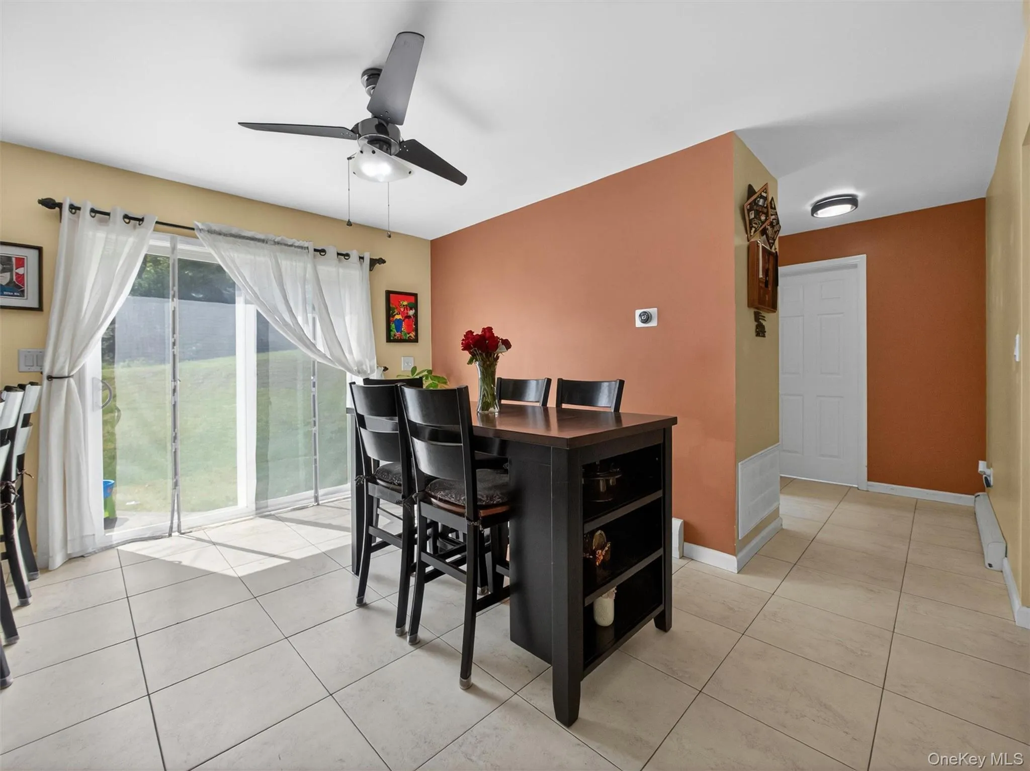 Bright kitchenette area featuring tile floors, casual dining space, and sliding doors leading to the outdoor deck. Bright kitchenette area featuring tile floors, casual dining space, and sliding doors leading to the outdoor deck.