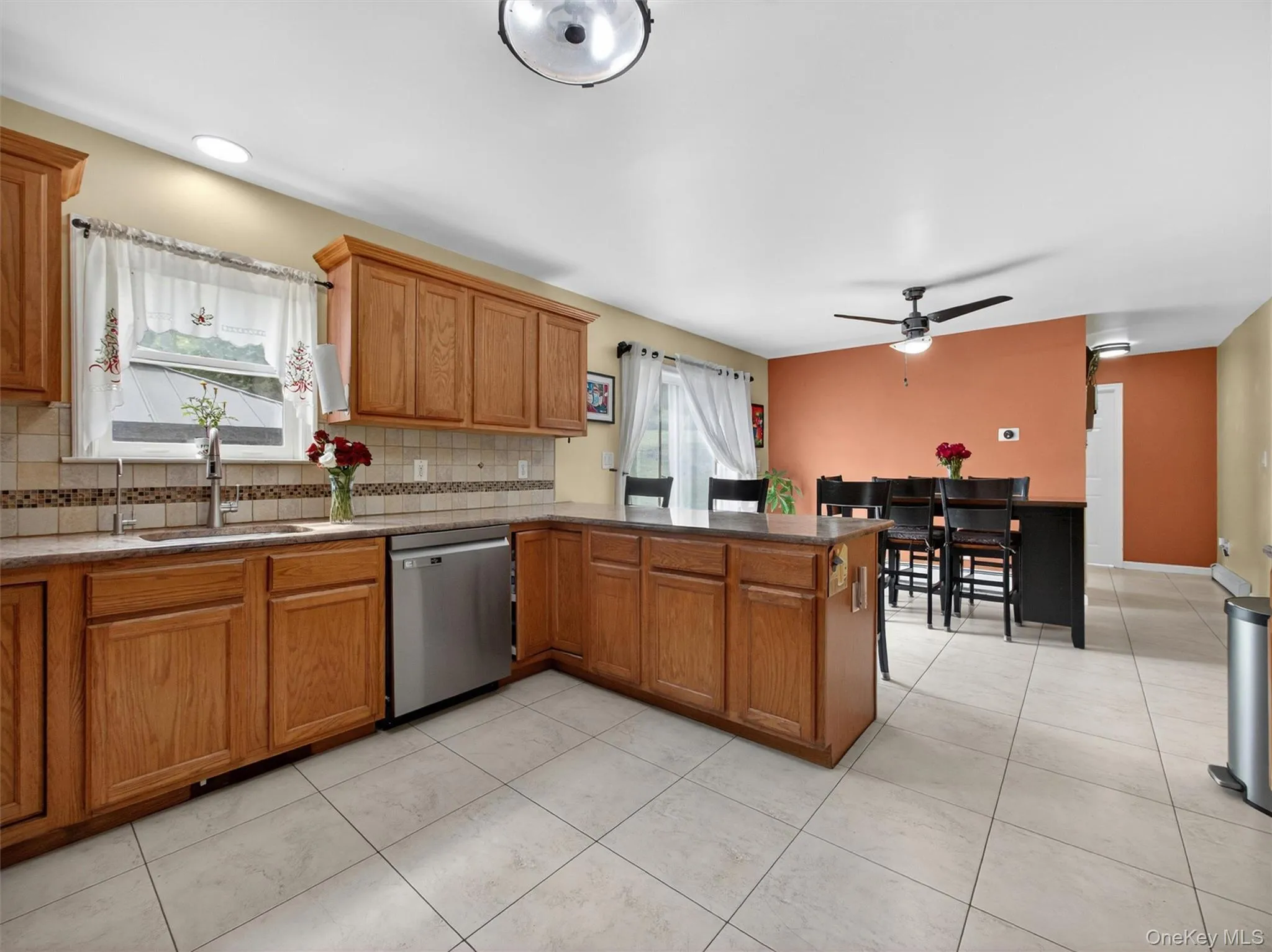 Spacious kitchen with ample counter space, tile backsplash, and beautiful flow into the surrounding living areas. Spacious kitchen with ample counter space, tile backsplash, and beautiful flow into the surrounding living areas.