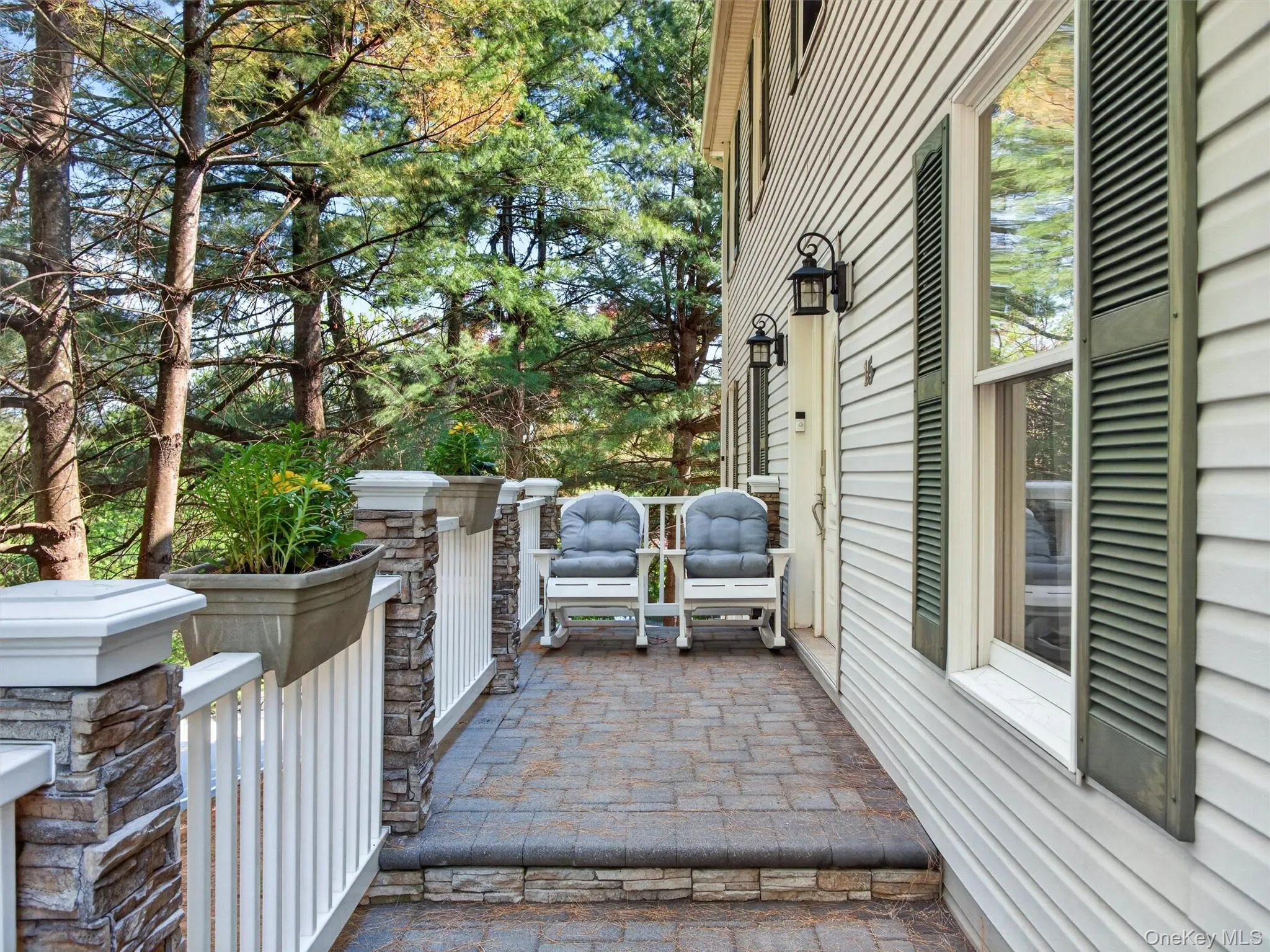 Additional front perspective featuring the home’s beautiful setting, spacious layout, and charming curb appeal. Additional front perspective featuring the home’s beautiful setting, spacious layout, and charming curb appeal.