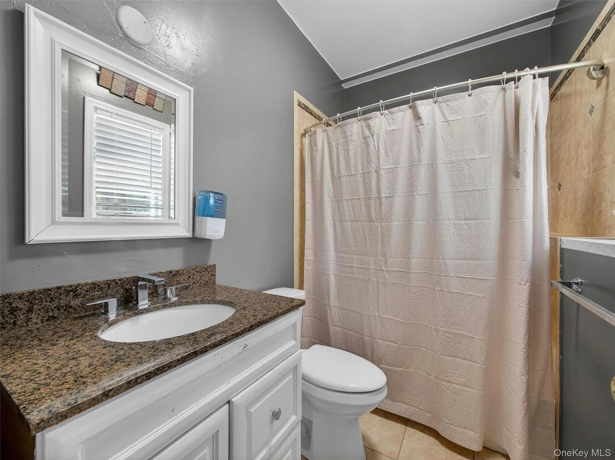 Convenient lower-level full bathroom featuring a functional layout and easy access from the recreation and bonus areas. Convenient lower-level full bathroom featuring a functional layout and easy access from the recreation and bonus areas.
