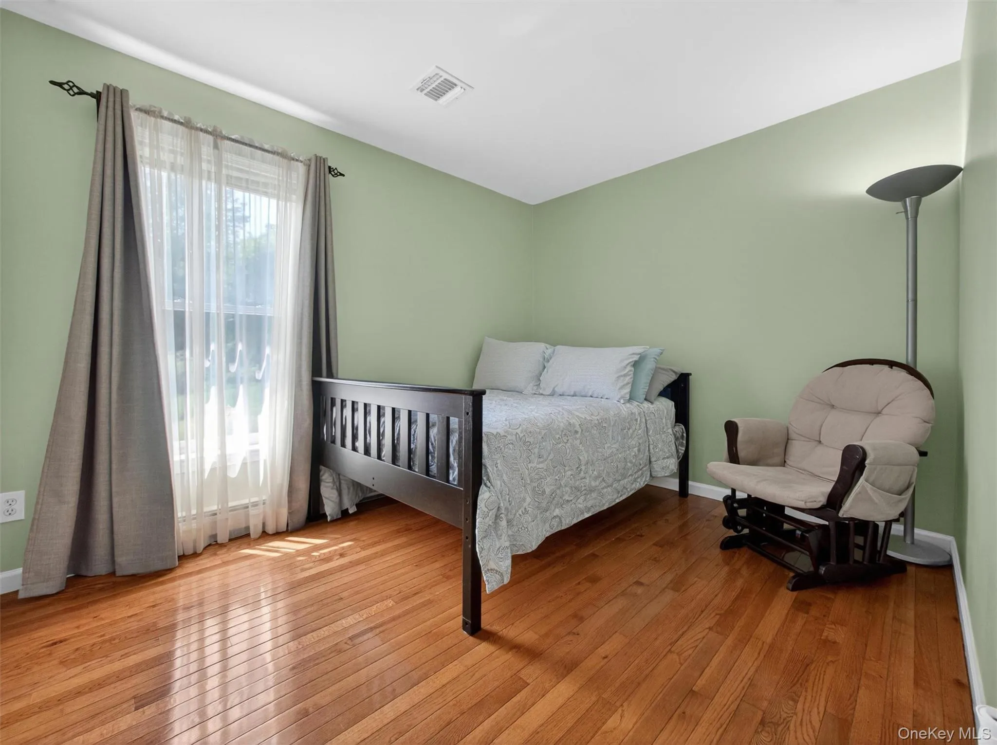 Bedroom Four – Bright bedroom featuring hardwood floors, large windows, and a comfortable layout Bedroom Four – Bright bedroom featuring hardwood floors, large windows, and a comfortable layout