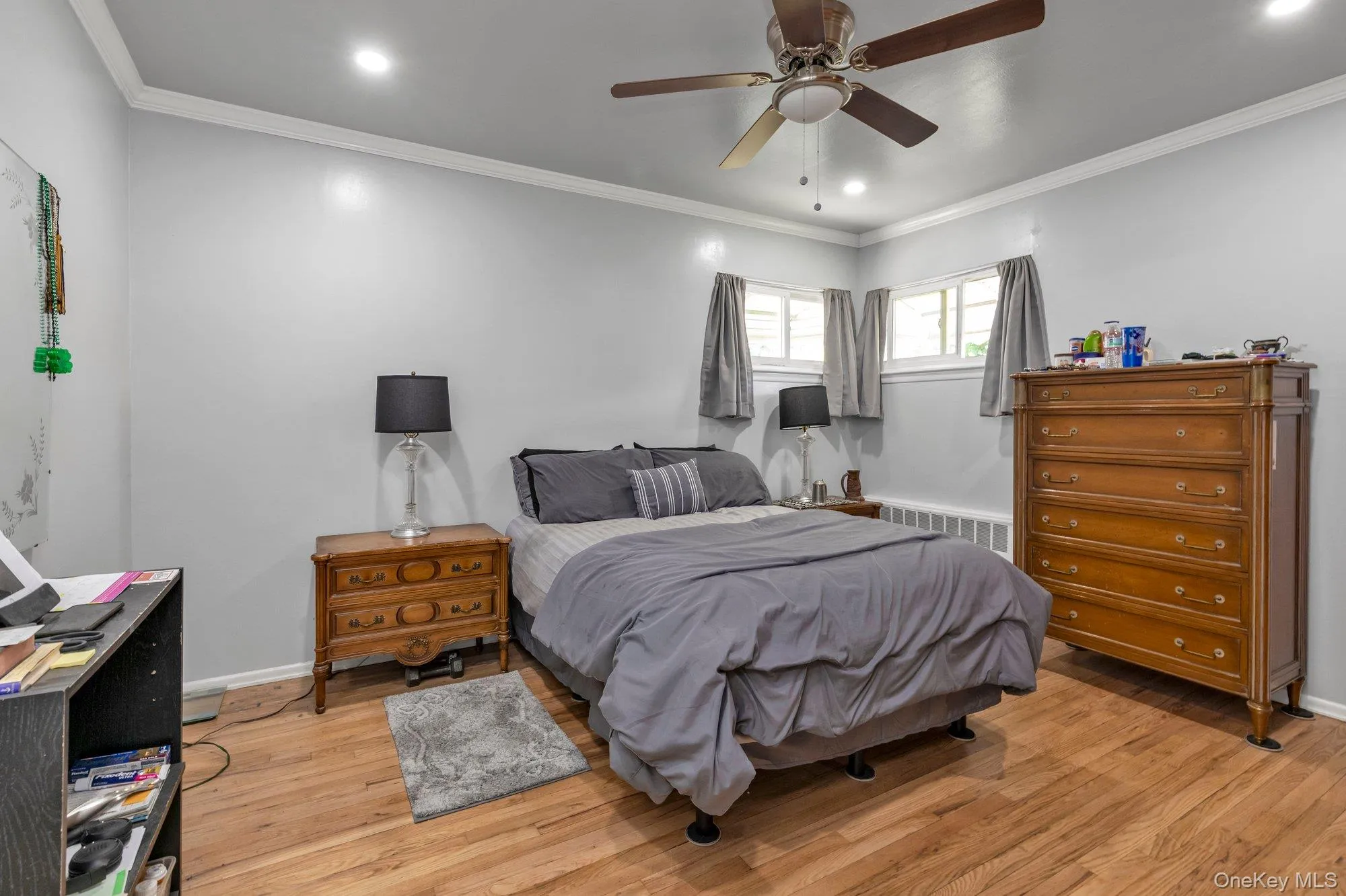 Bedroom featuring wood-finish flooring, recessed lighting, and a ceiling fan Bedroom featuring wood-finish flooring, recessed lighting, and a ceiling fan