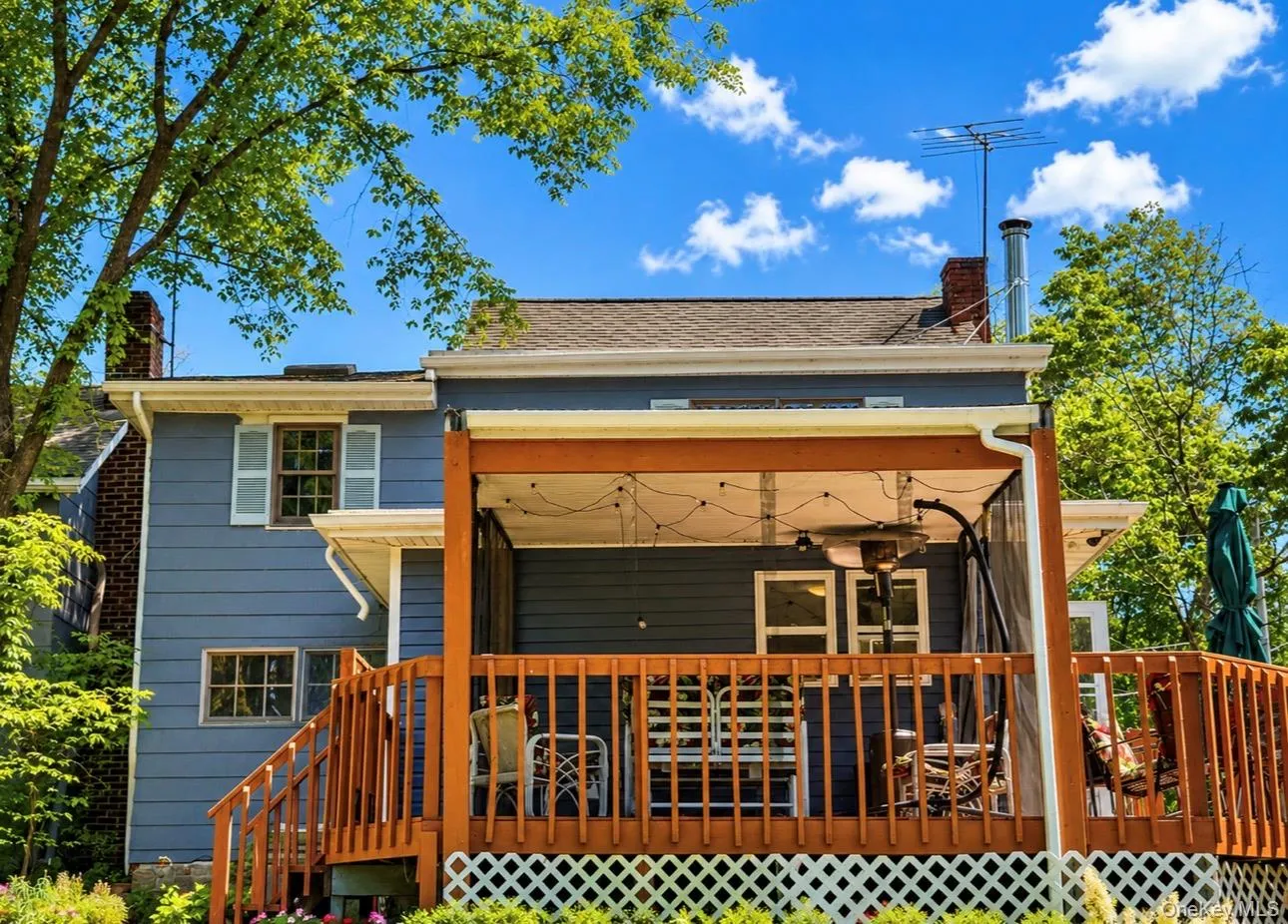 Expansive wood deck featuring a covered outdoor area with string lighting Expansive wood deck featuring a covered outdoor area with string lighting