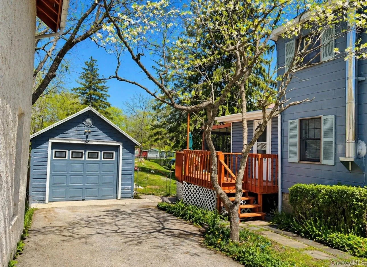Detached garage with paneled door and upper window lights Detached garage with paneled door and upper window lights