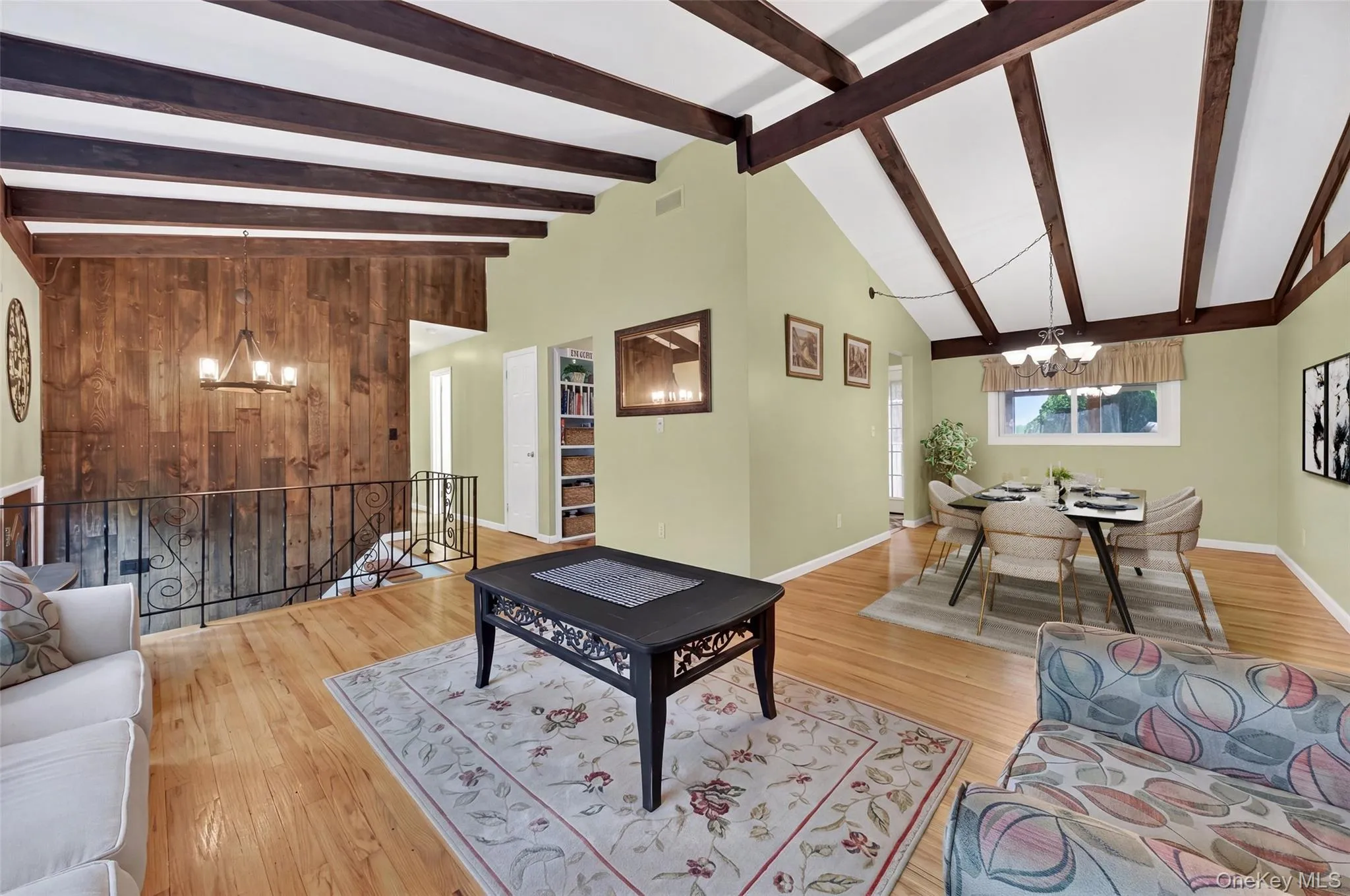 Vaulted ceilings with exposed wood beams, hardwood flooring, open to formal dining room Vaulted ceilings with exposed wood beams, hardwood flooring, open to formal dining room