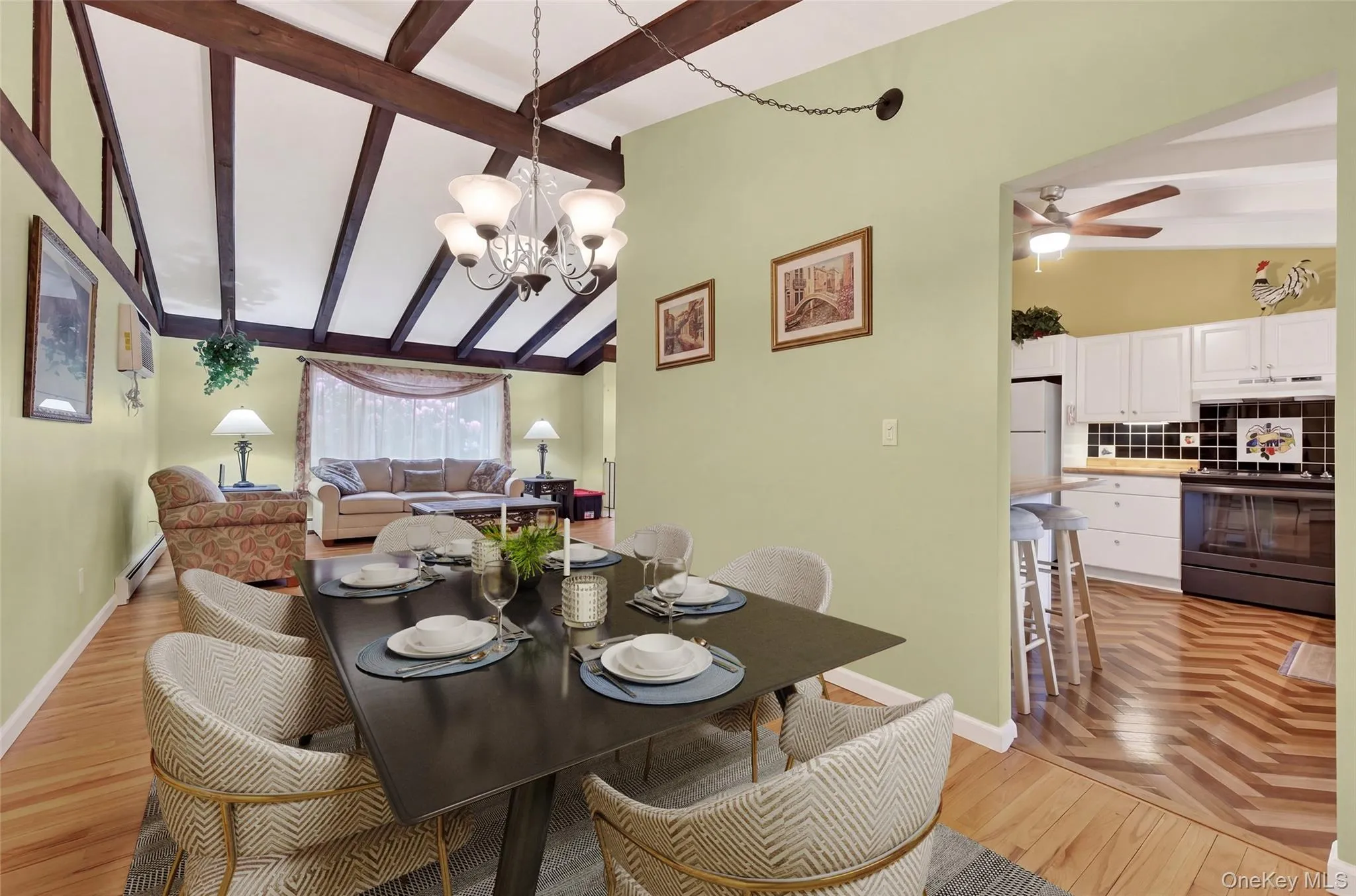 Dining room featuring exposed wood beams, hardwood flooring Dining room featuring exposed wood beams, hardwood flooring