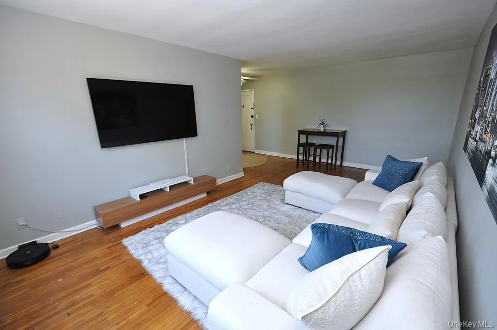 The large living room has hardwood floors and opens to the dining are and entry foyer. The living area and dining area is approx 20'-4" x 11'-5". The large living room has hardwood floors and opens to the dining are and entry foyer. The living area and dining area is approx 20'-4" x 11'-5".