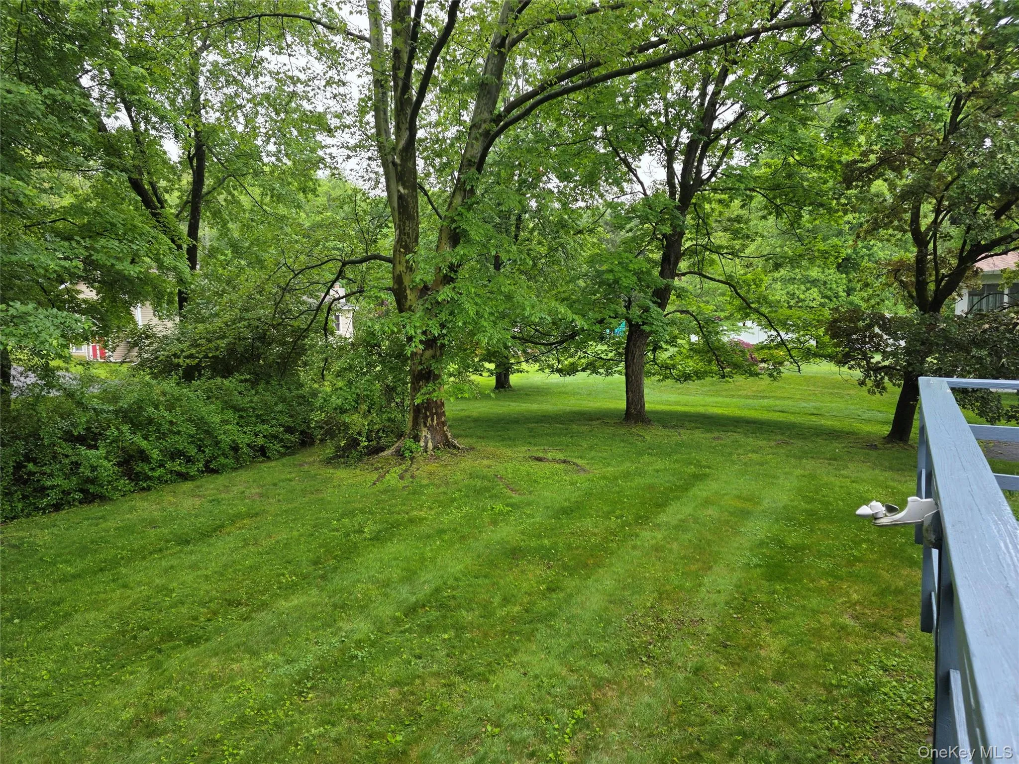 View from deck looking out to flat backyard for entertaining and sports. View from deck looking out to flat backyard for entertaining and sports.