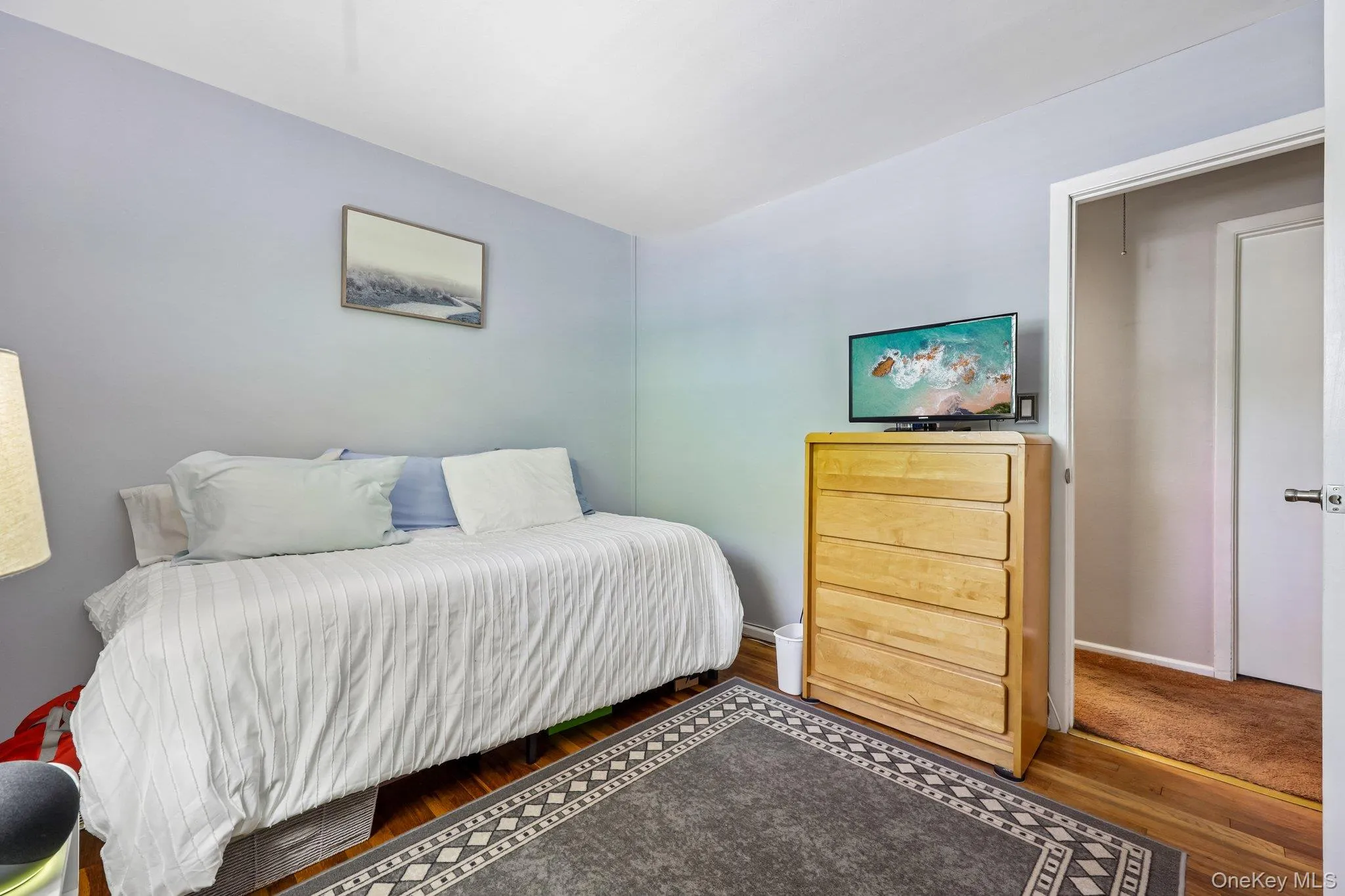 Bright room featuring light-toned walls, finished oak flooring, white moulding and closet. Bright room featuring light-toned walls, finished oak flooring, white moulding and closet.