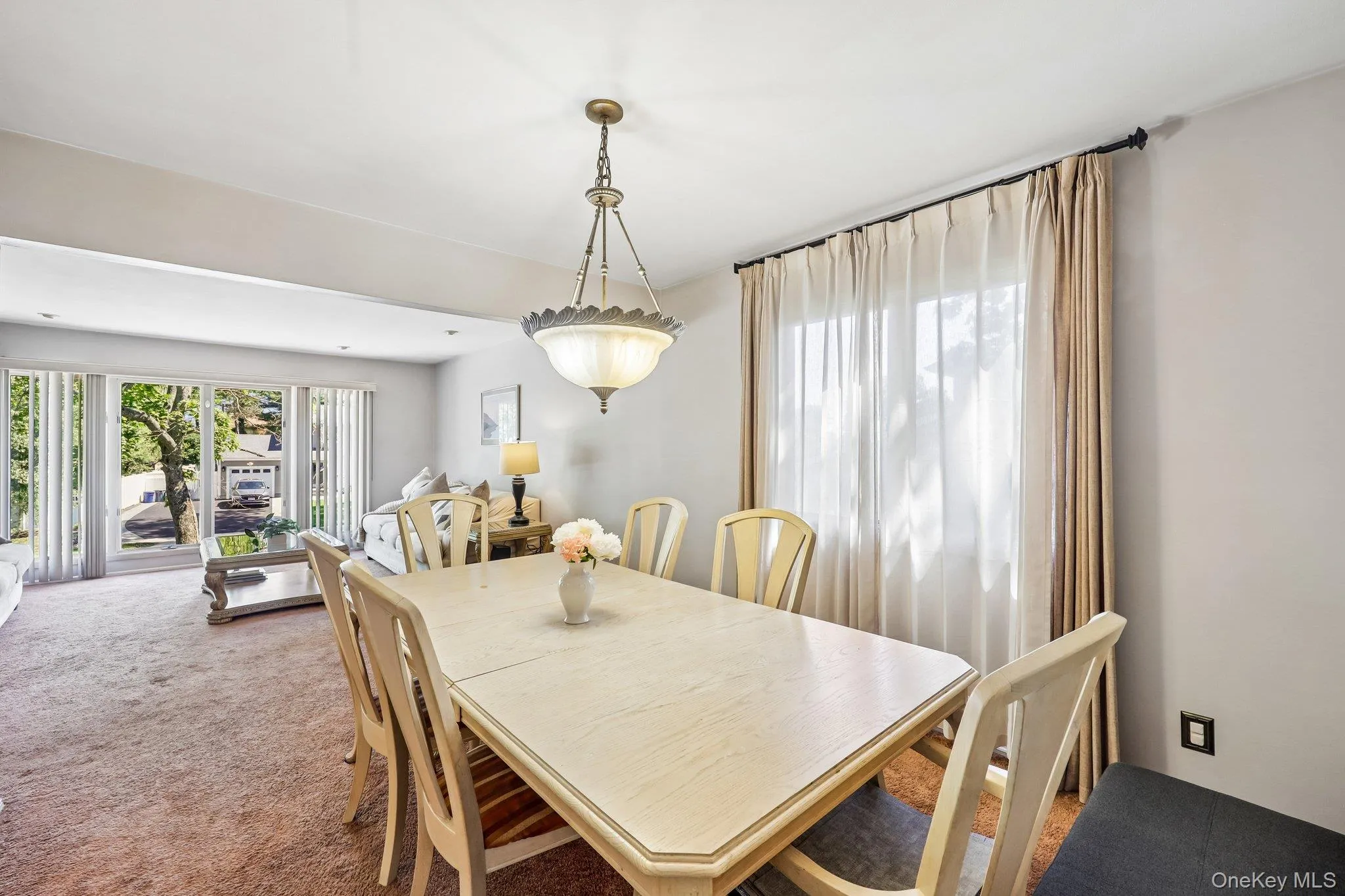 Bright sun filled Dining Room with Open concept to Living Room, carpet over wood flooring Bright sun filled Dining Room with Open concept to Living Room, carpet over wood flooring