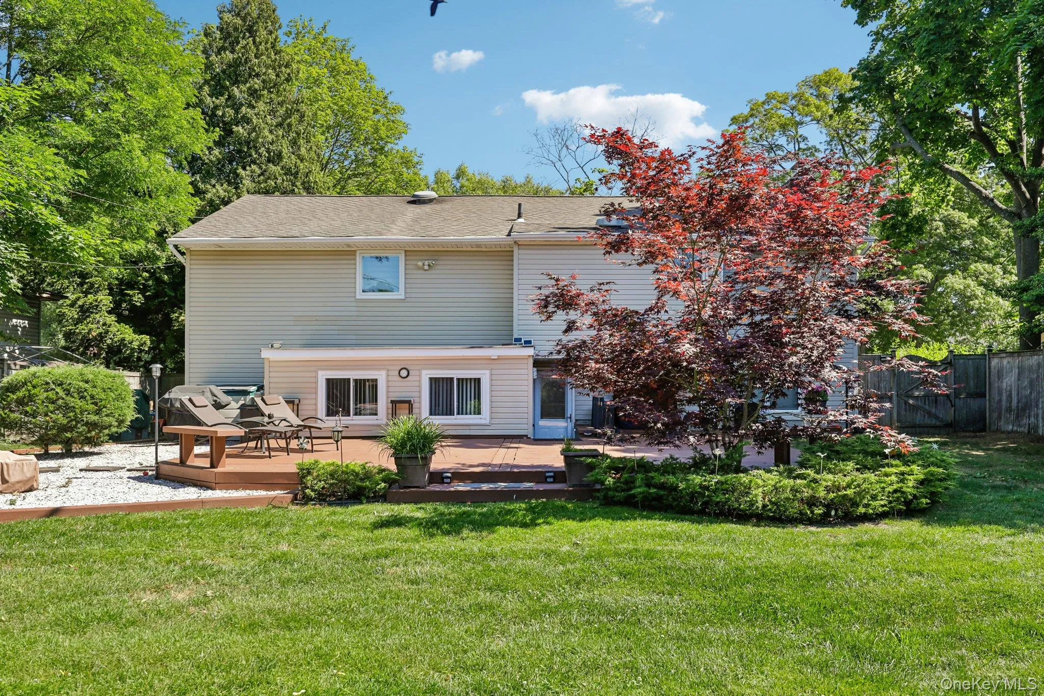 Beautifully Landscaped Yard, with stone bbq area and fire pit, Freshly painted deck with entrance to Summer Kitchen and Lower Den. Beautifully Landscaped Yard, with stone bbq area and fire pit, Freshly painted deck with entrance to Summer Kitchen and Lower Den.