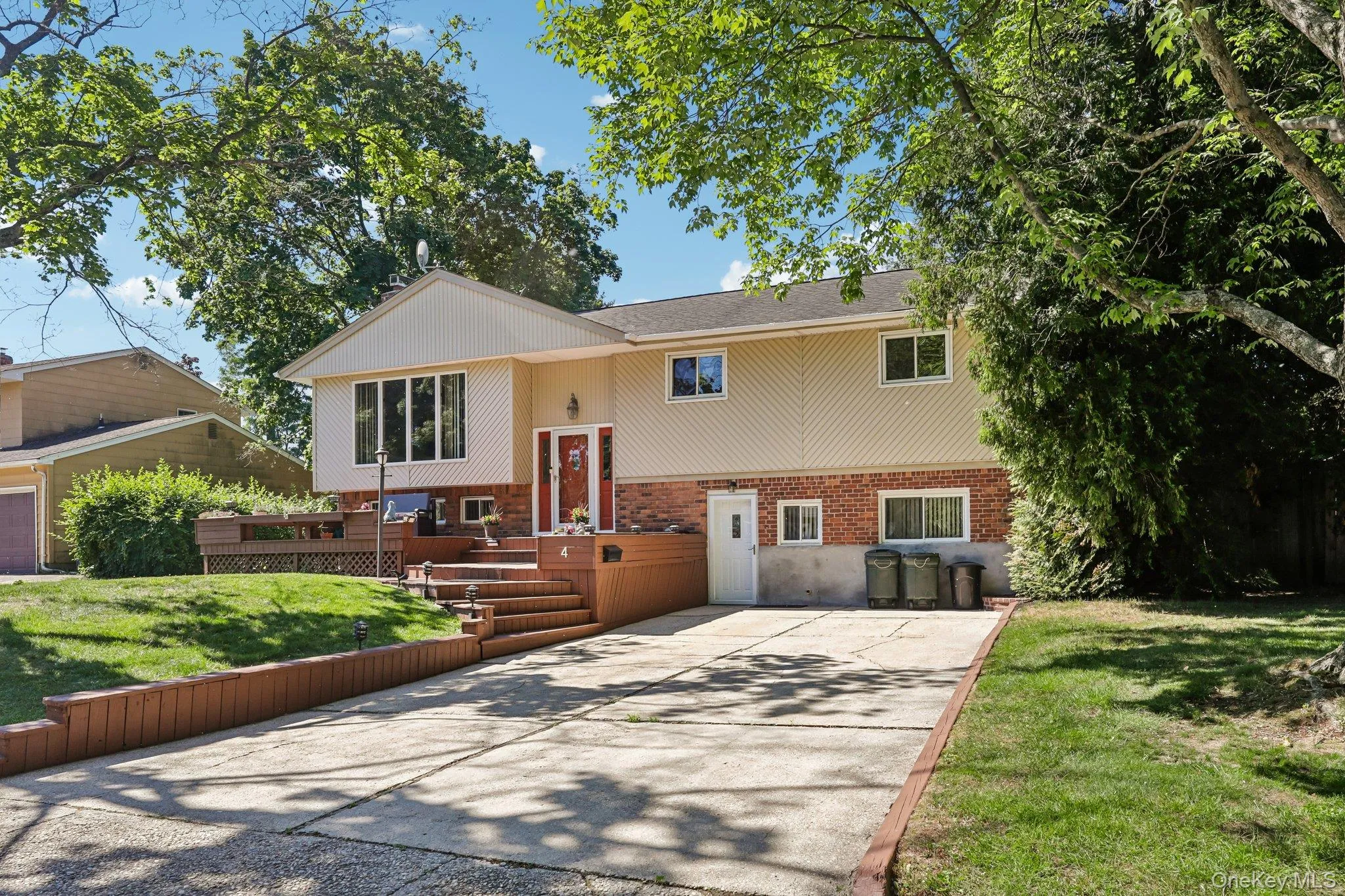 Side street view, asphalt driveway, entrance to legal garage conversion, newly finished open porch Side street view, asphalt driveway, entrance to legal garage conversion, newly finished open porch