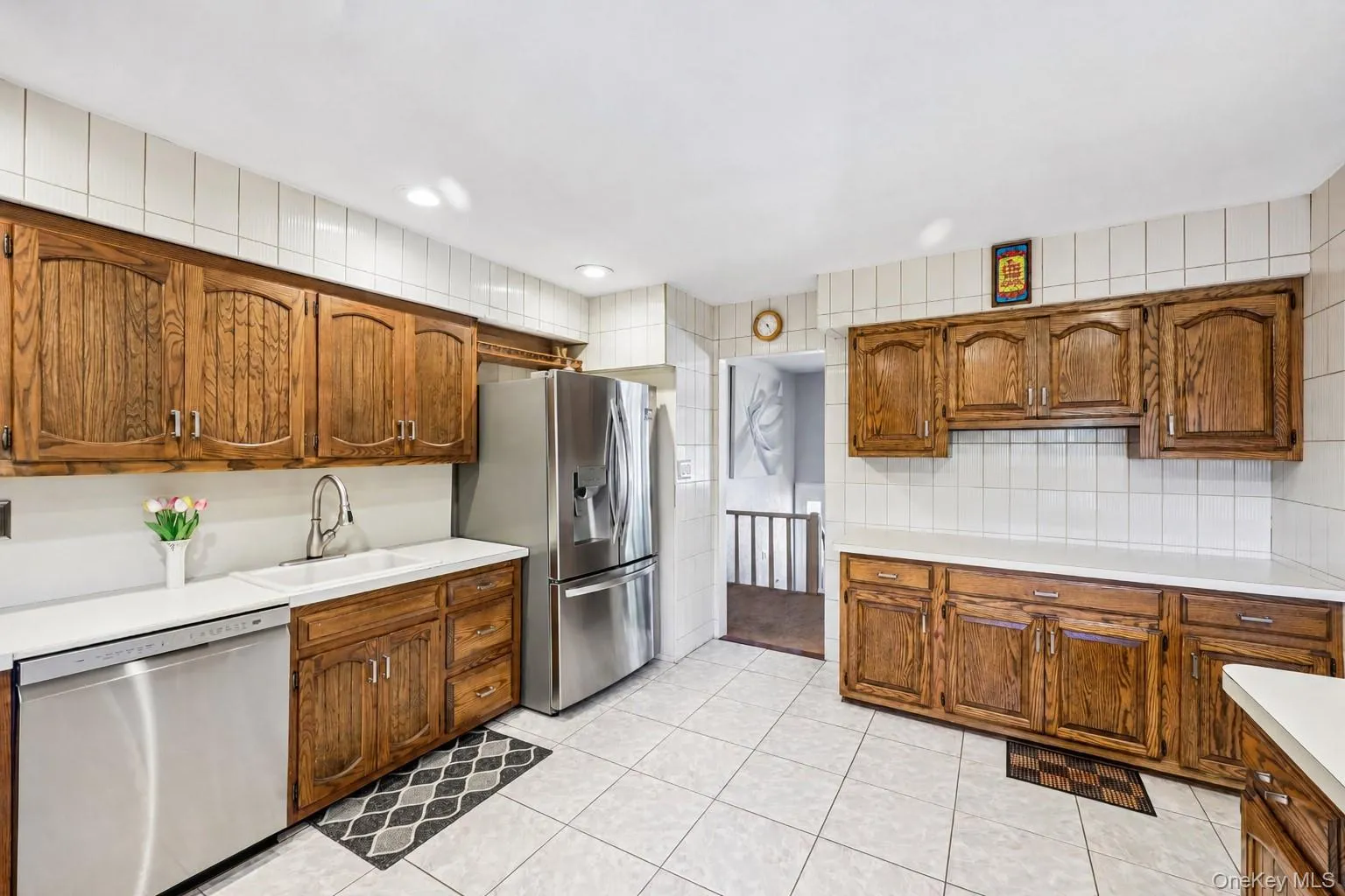 Eat-In-Kitchen featuring wood cabinetry, high hats, lots of counter space, tile flooring, stainless appliances including large gas range with professional grade hood. Eat-In-Kitchen featuring wood cabinetry, high hats, lots of counter space, tile flooring, stainless appliances including large gas range with professional grade hood.