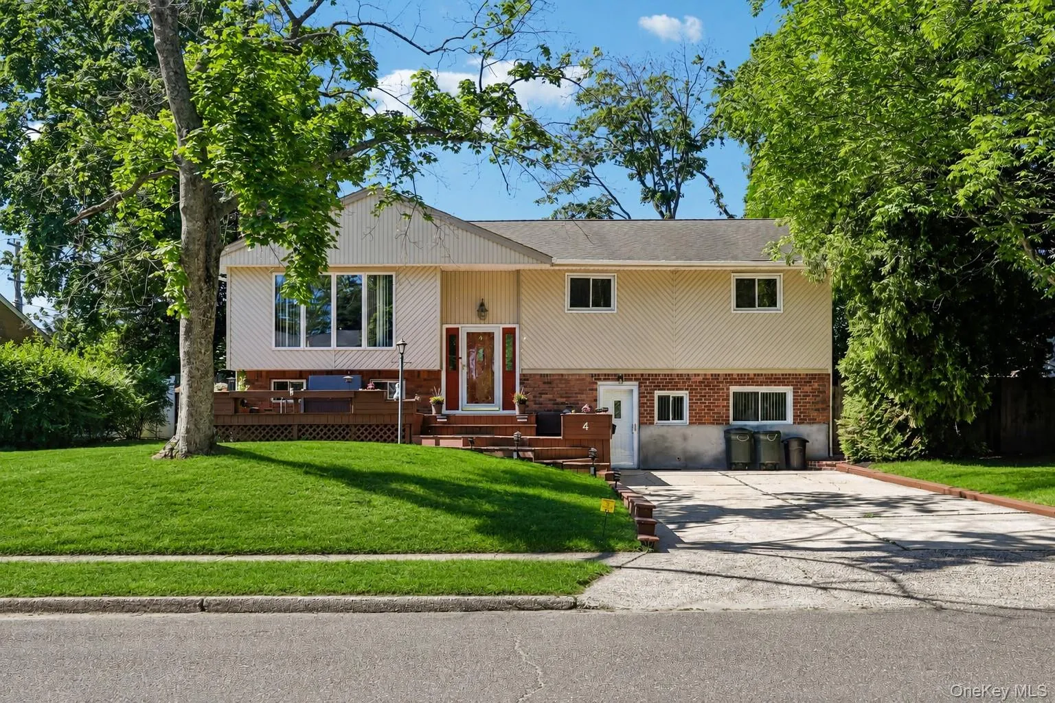 Home with brick & siding front, beautiful grass, asphalt driveway, and newly finished open porch Home with brick & siding front, beautiful grass, asphalt driveway, and newly finished open porch