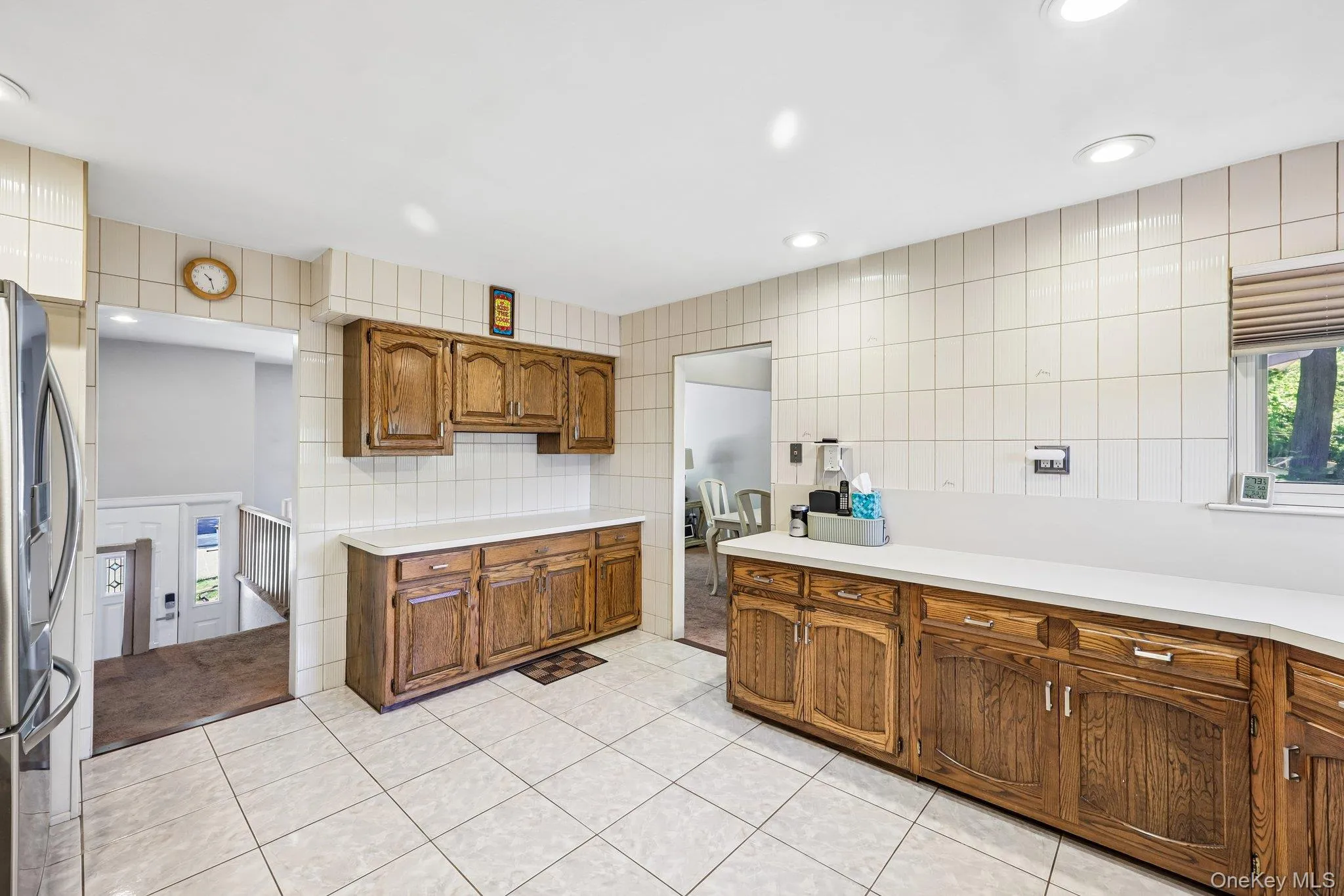 Eat-In-Kitchen featuring wood cabinetry, high hats, lots of counter space, tile flooring, stainless appliances, including large gas range with professional grade hood. Eat-In-Kitchen featuring wood cabinetry, high hats, lots of counter space, tile flooring, stainless appliances, including large gas range with professional grade hood.