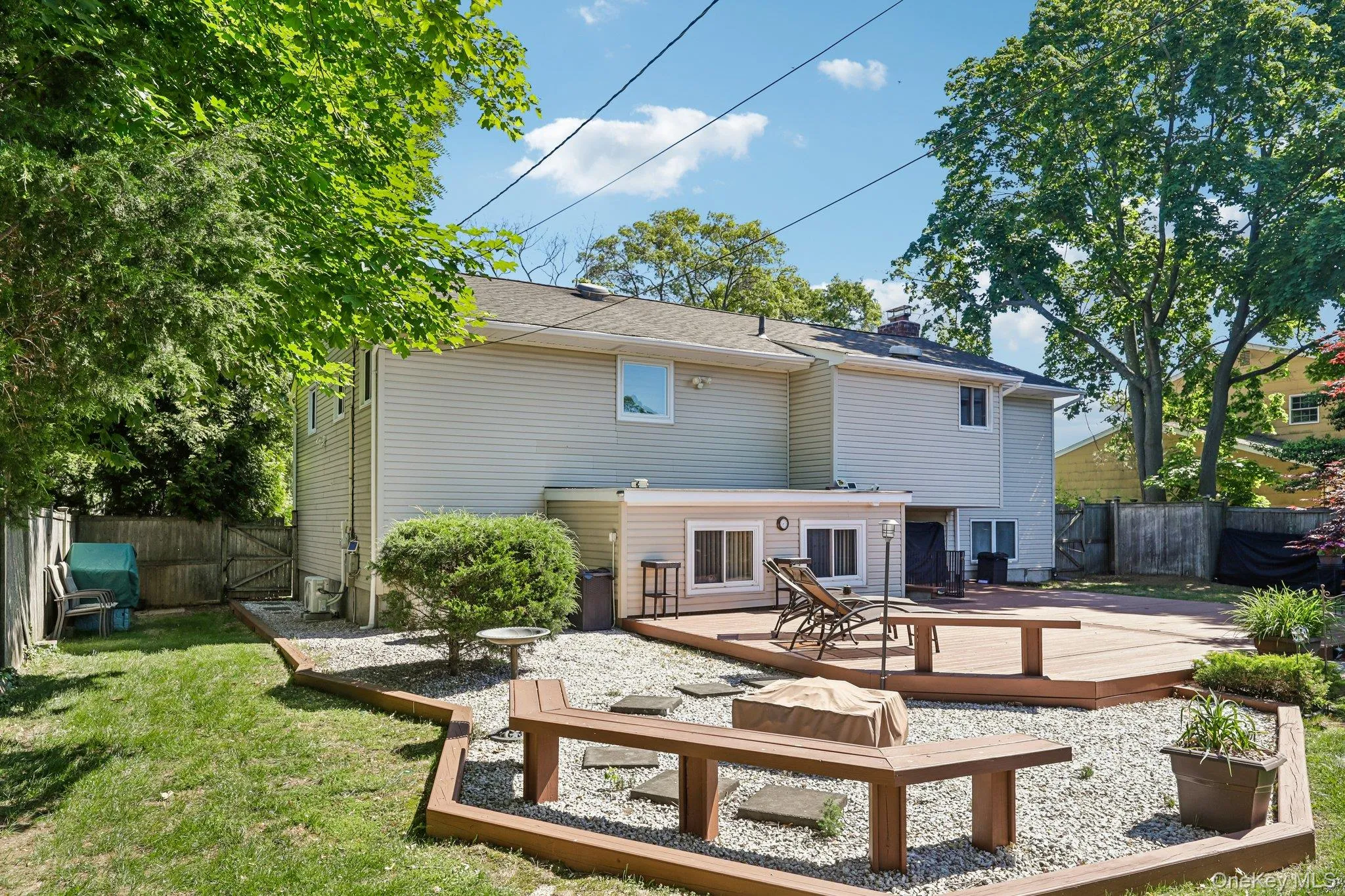 Beautifully landscaped yard, with stone fire pit and BBQ area, freshly painted deck with entrance to summer kitchen and separate entrance to Den. Beautifully landscaped yard, with stone fire pit and BBQ area, freshly painted deck with entrance to summer kitchen and separate entrance to Den.