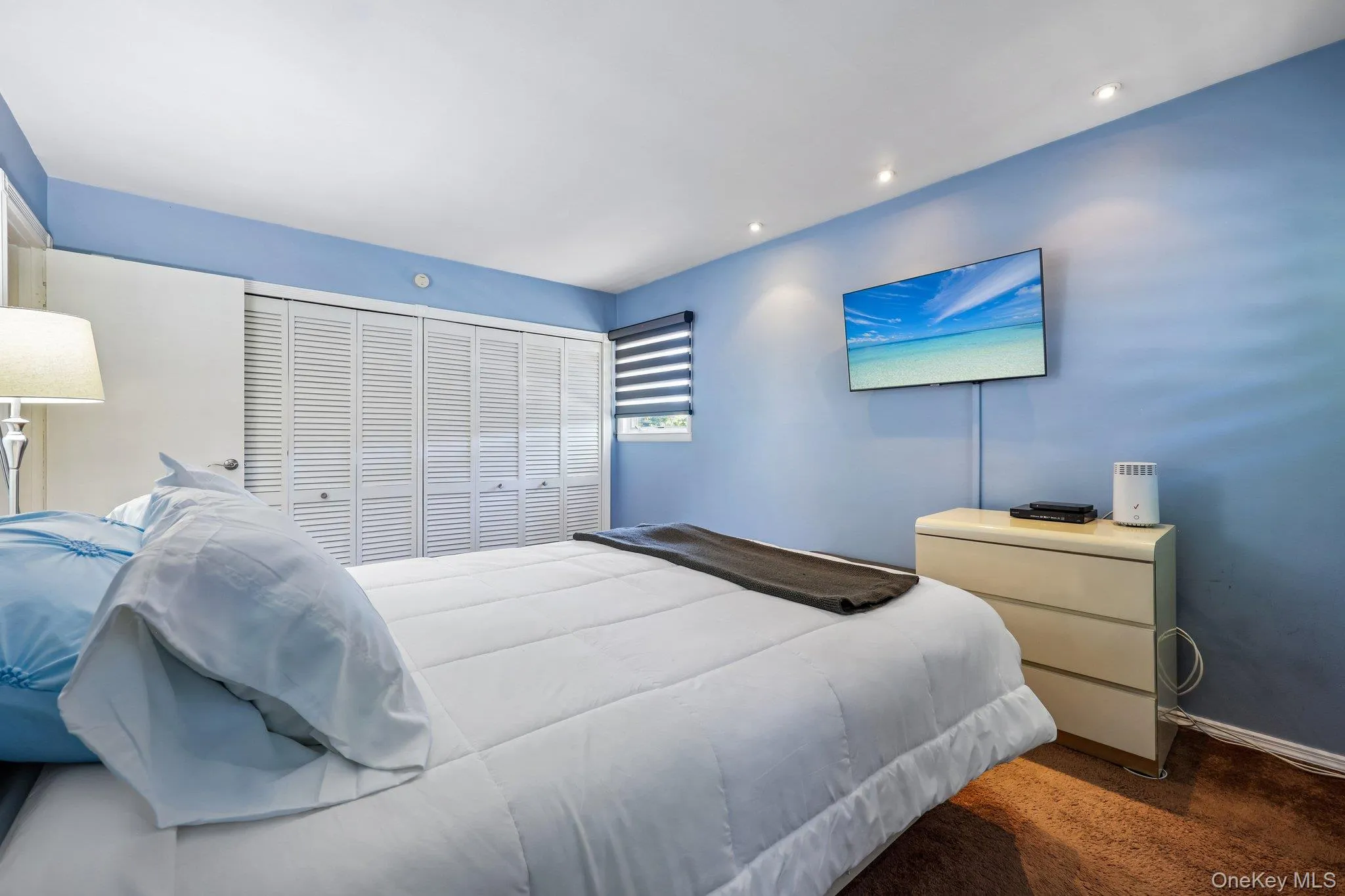Large Primary Bedroom featuring Plenty of light from 3 windows, carpet over wood flooring, high hats, Large double closet Large Primary Bedroom featuring Plenty of light from 3 windows, carpet over wood flooring, high hats, Large double closet