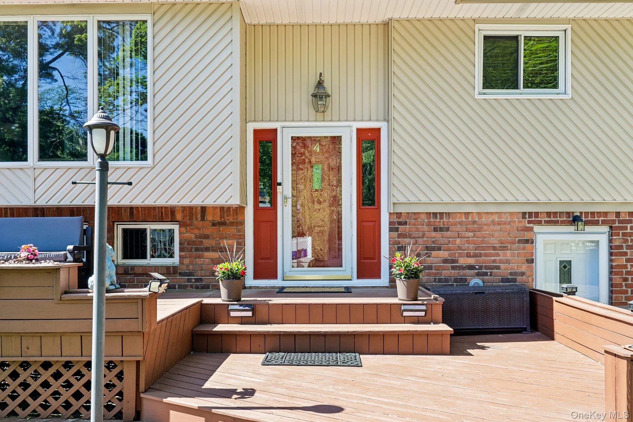 Home entrance with brick, siding, beautiful newly finished porch Home entrance with brick, siding, beautiful newly finished porch