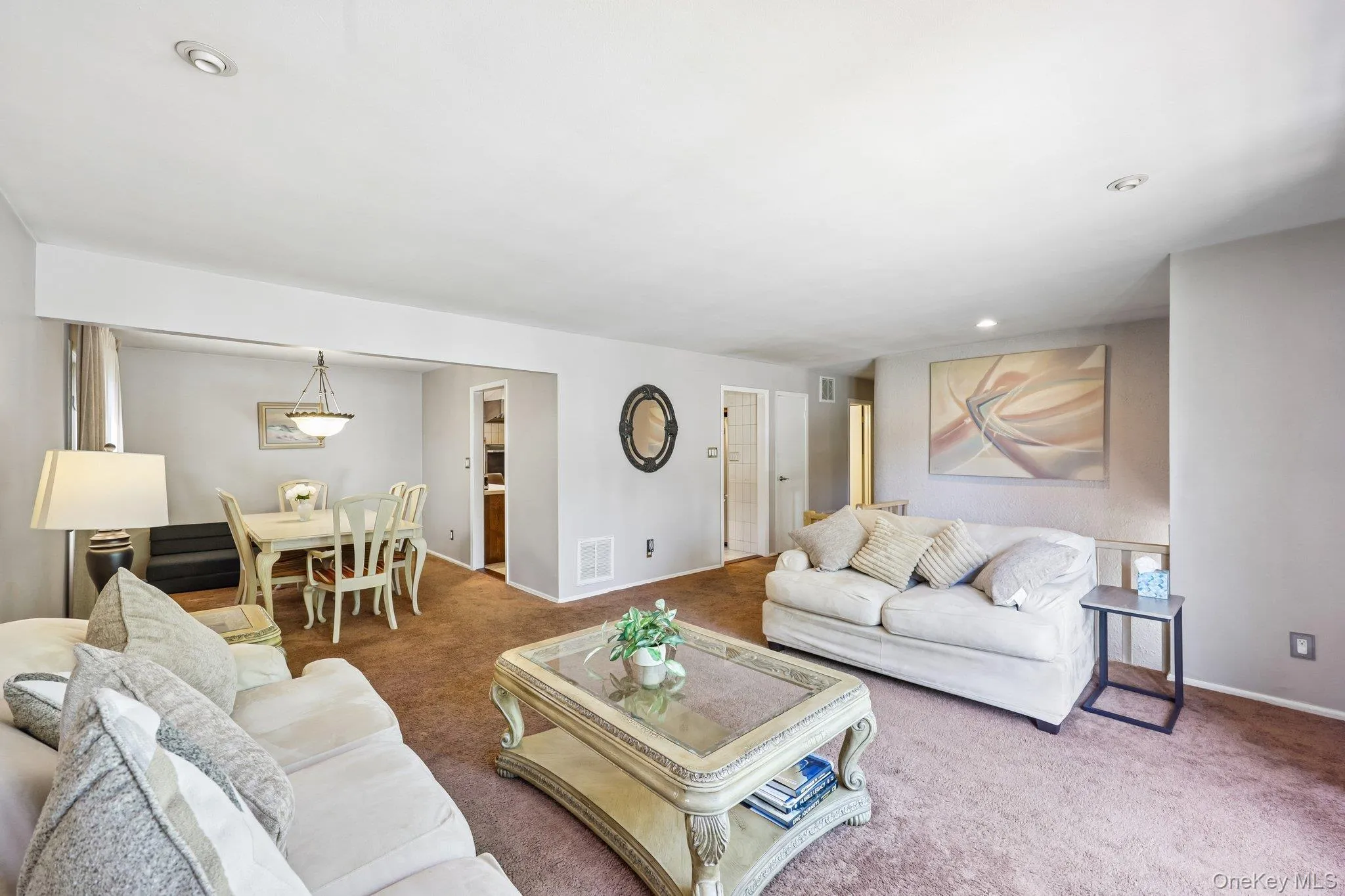 Open Living & Dining room with high hats, carpeting over wood floors Open Living & Dining room with high hats, carpeting over wood floors