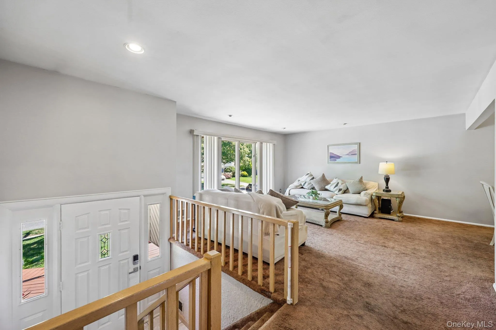 Entry, Large Living Room view with big to floor windows, high hats, carpeting over wood flooring. Entry, Large Living Room view with big to floor windows, high hats, carpeting over wood flooring.