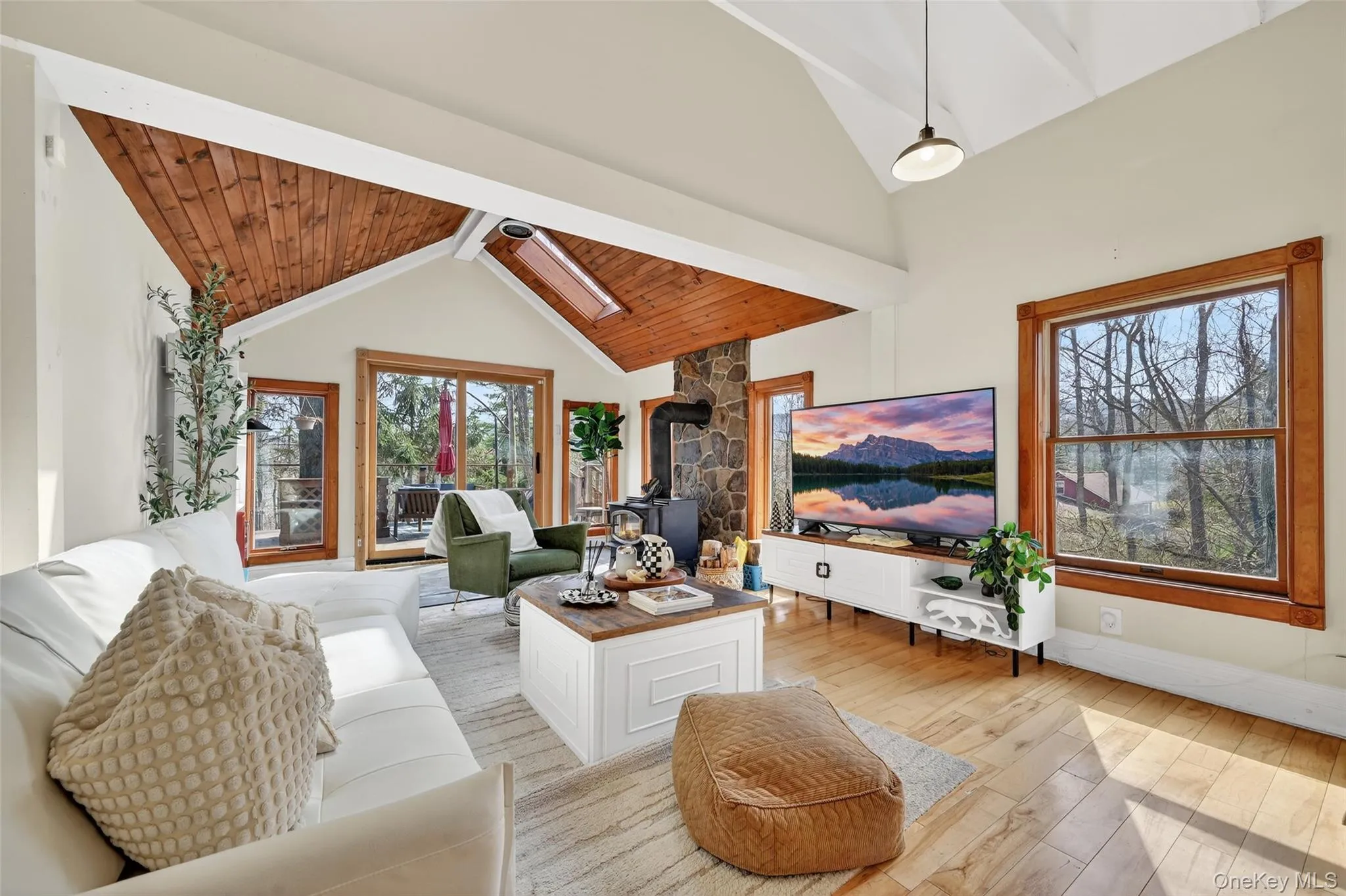 Vaulted ceiling with wood paneling and exposed white beams Vaulted ceiling with wood paneling and exposed white beams