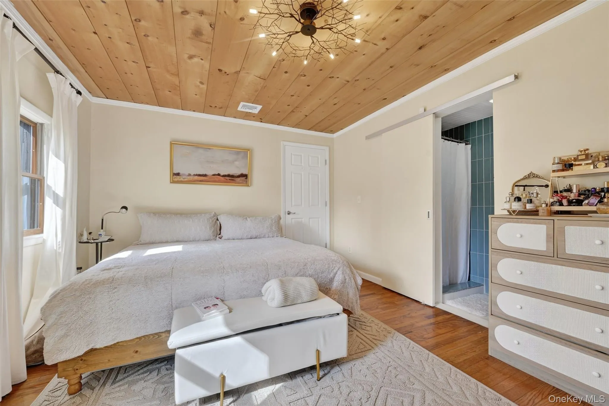 Room featuring a wood-panel ceiling with a decorative light fixture Room featuring a wood-panel ceiling with a decorative light fixture