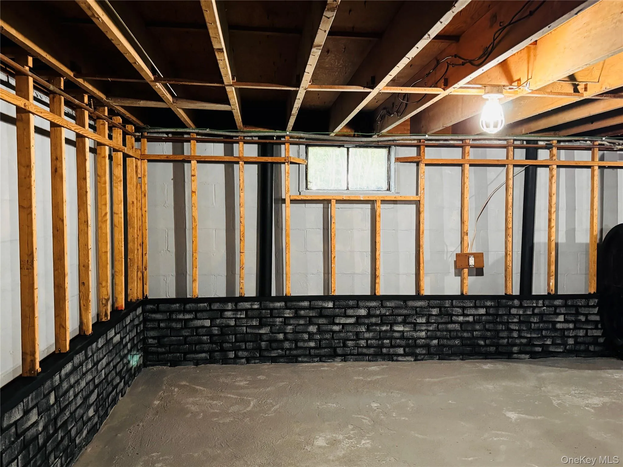 Basement with concrete flooring and brick boarder. Basement with concrete flooring and brick boarder.